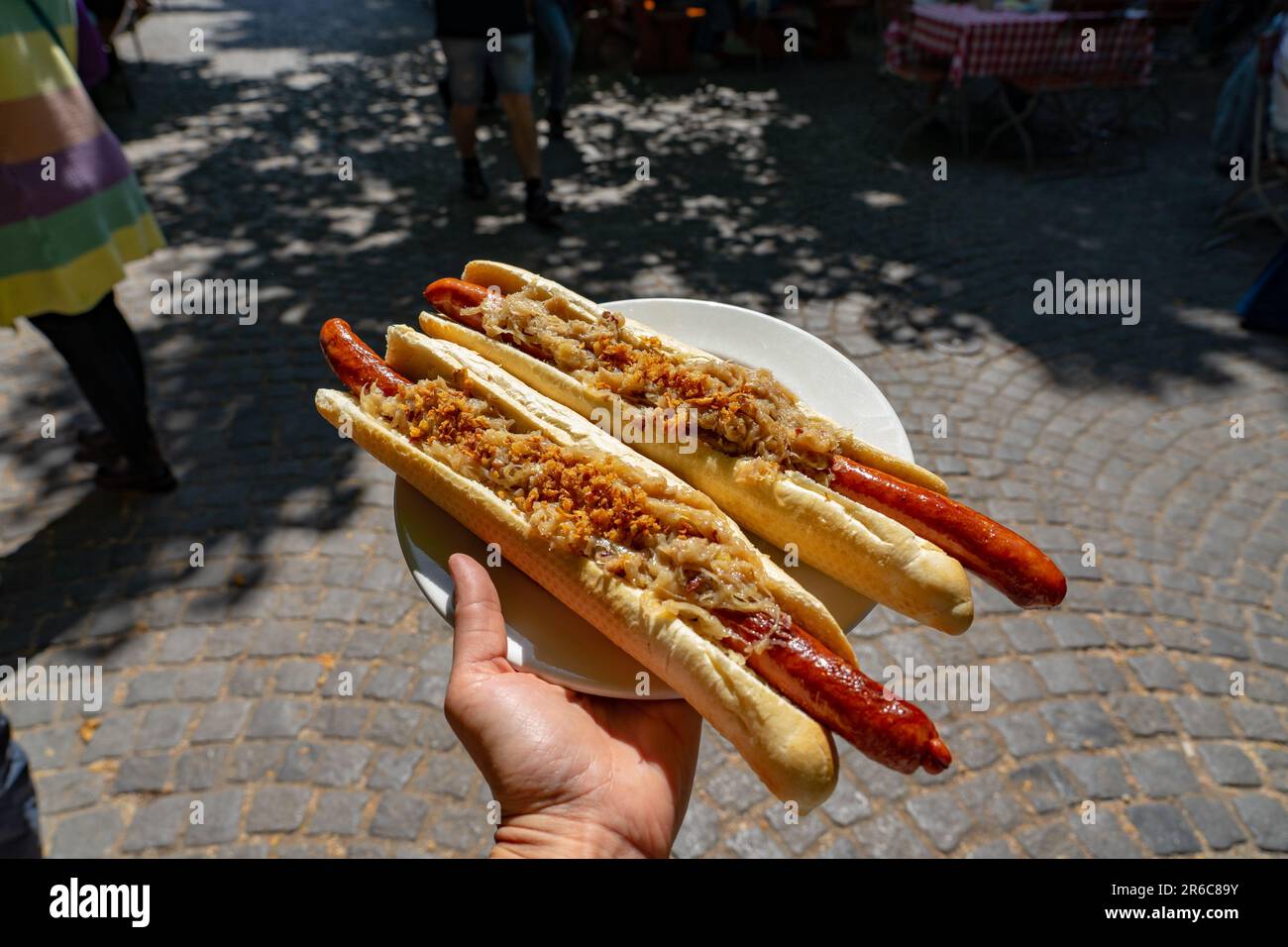 german bavarian hot dog in viktualienmarkt munich with sauerkraut street food . Stock Photo