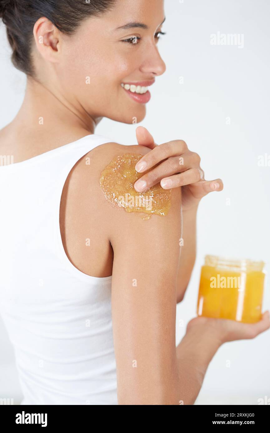 Woman applying body scrub Stock Photo