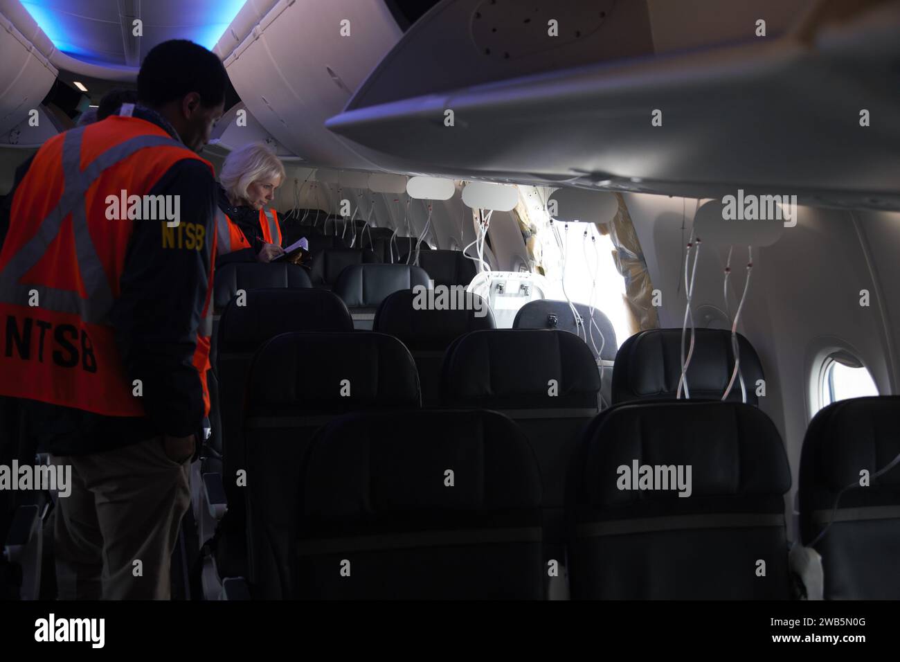 Portland, United States. 08th Jan, 2024. NTSB investigators examine the missing door plug section on Alaska Airlines Flight 1282, a Boeing 737-9 MAX commercial aircraft, January 7, 2024 in Portland, Oregon. The aircraft suffered a blowout of a door plug on January 5th resulting in uncontrolled decompression of the aircraft and forcing an emergency landing. Credit: NTSB/National Transportation Safety Board/Alamy Live News Stock Photo