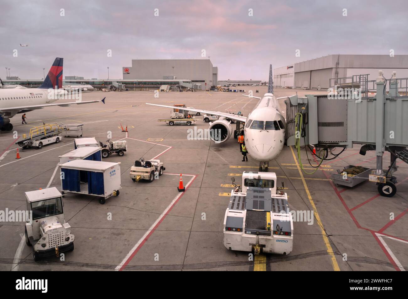 Toronto, Canada - 03 10 2024: Embraer E195-E2 jet airliner of Canadian airline Porter Airlines parked on the tarmac of Toronto Pearson International Stock Photo