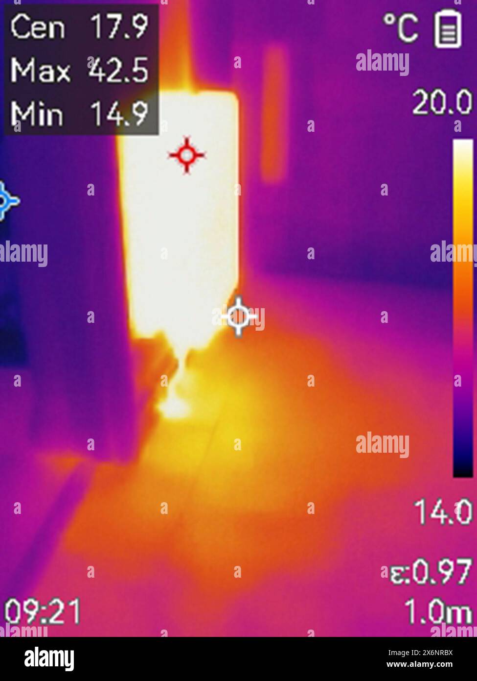 Leak detection using thermal imaging camera. Infrared image of a radiator and a heat plume in the floor from a leak in a hot water pipe. Central heati Stock Photo