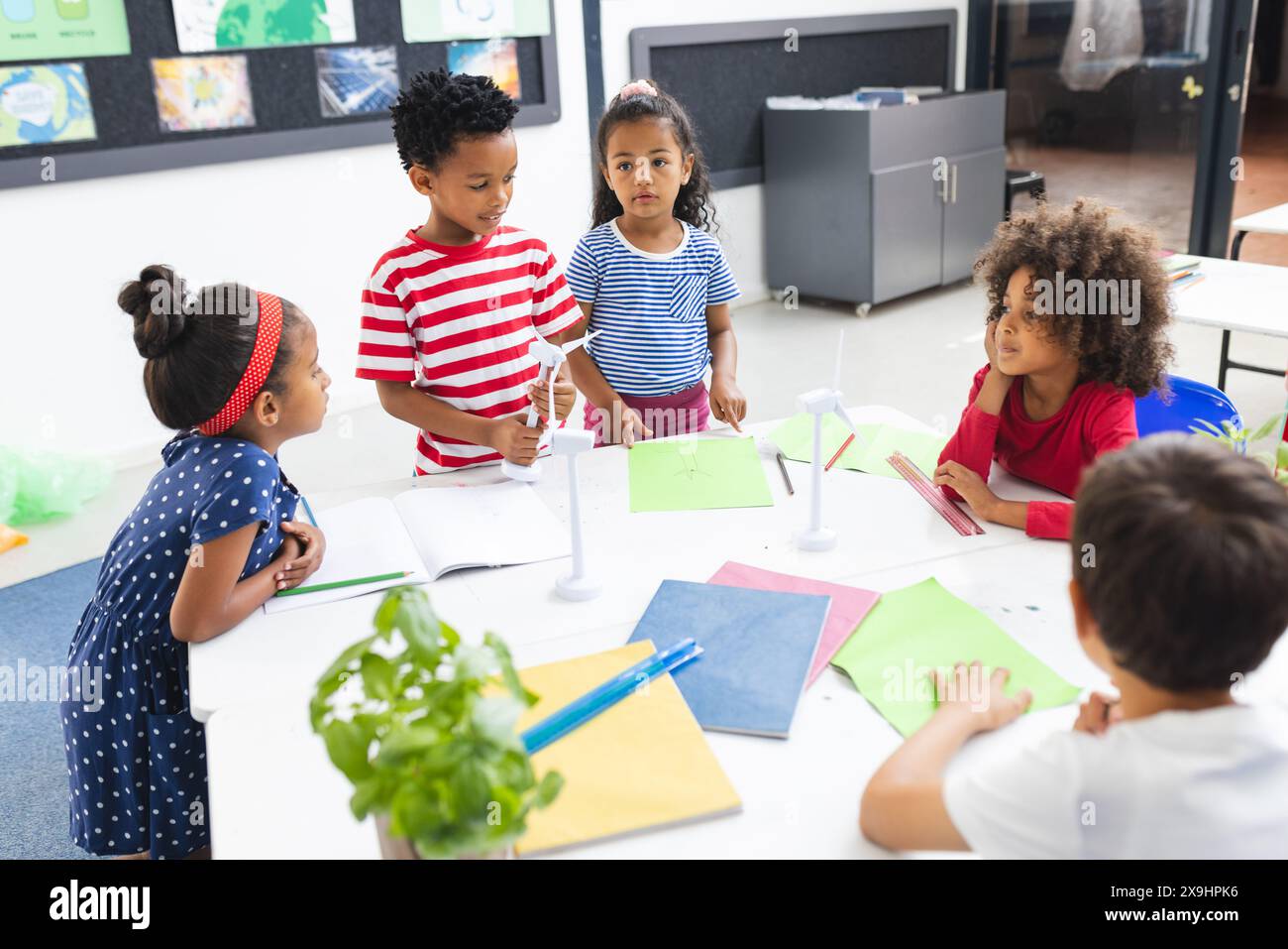 In school, diverse young students are discussing sustainability in classroom Stock Photo