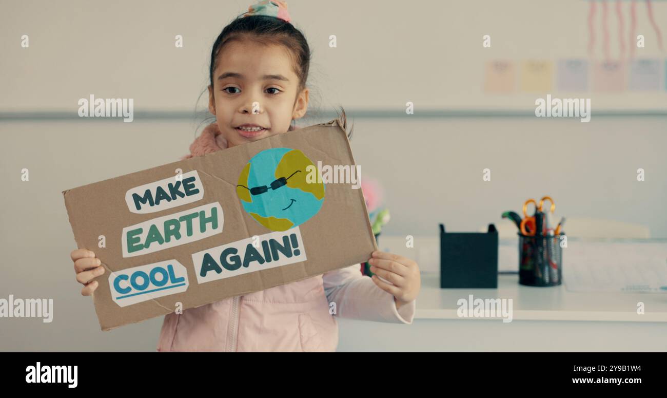 Student, girl and presentation with poster in classroom for eco friendly project, sustainability lesson and climate change. School, kid and oral Stock Photo