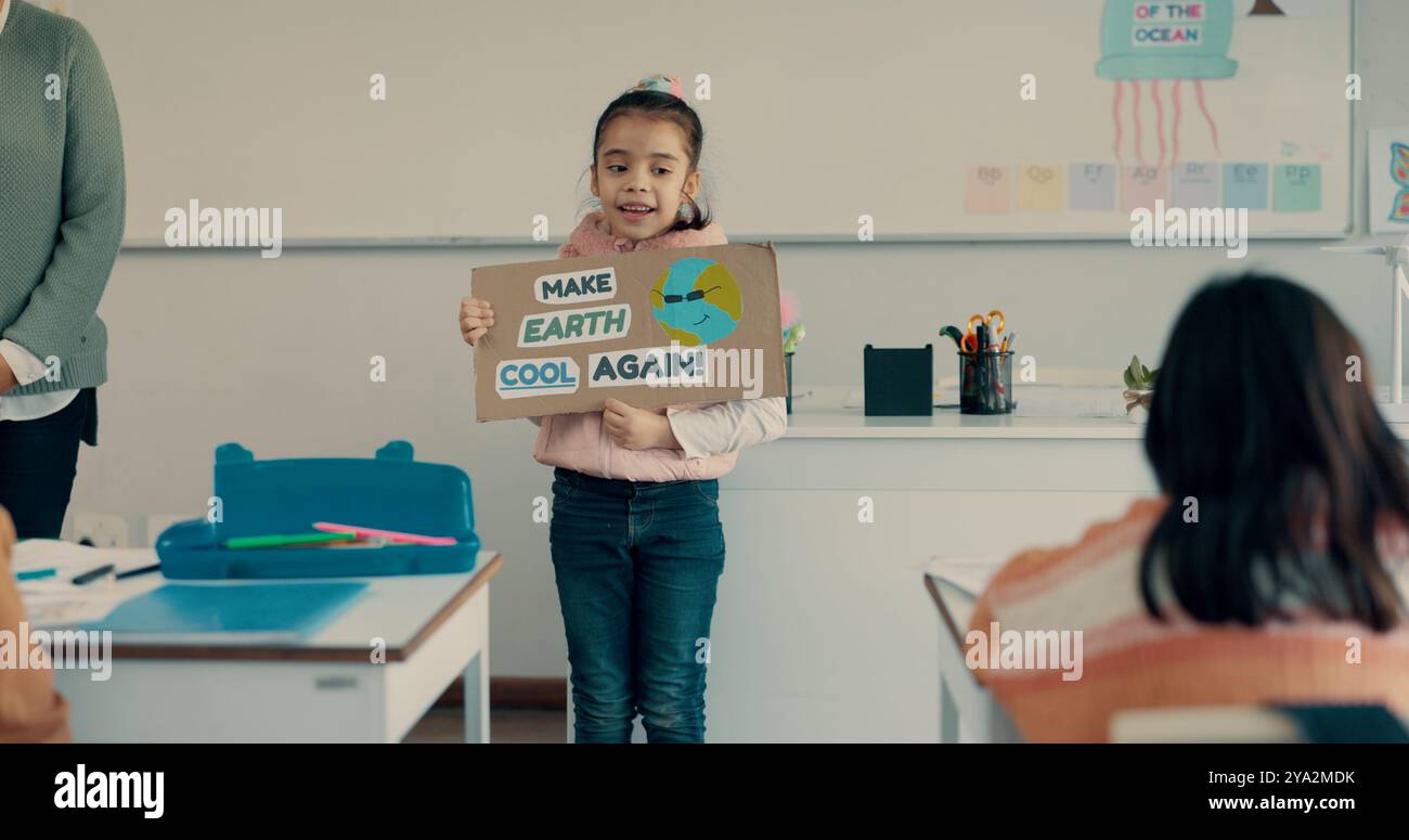 School, student and presentation with poster in classroom for eco friendly project, sustainability lesson and climate change. Girl, child and oral Stock Photo