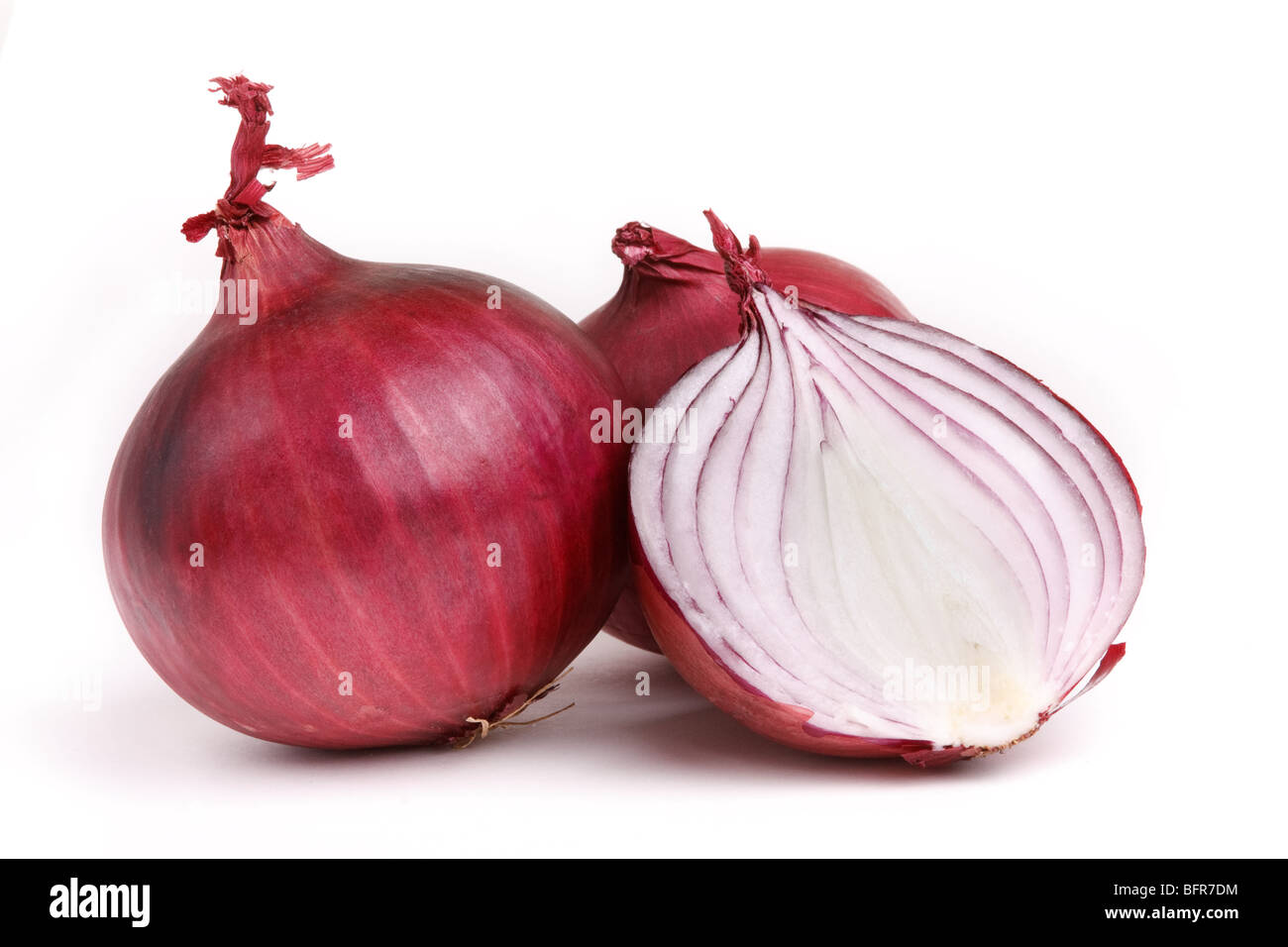 Red onions one sliced against white background. Stock Photo