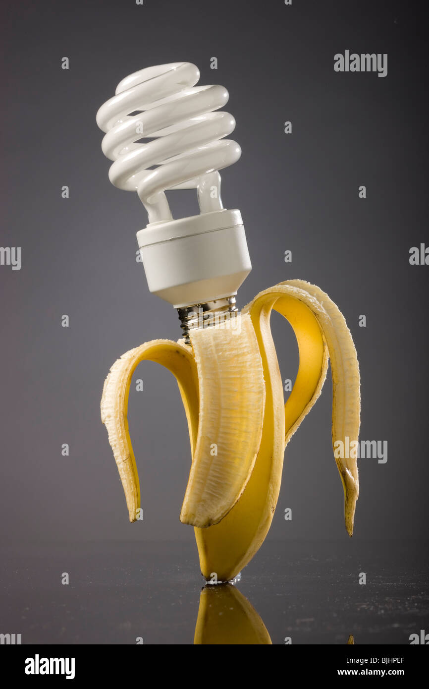 energy saving light bulb plugged into a banana Stock Photo