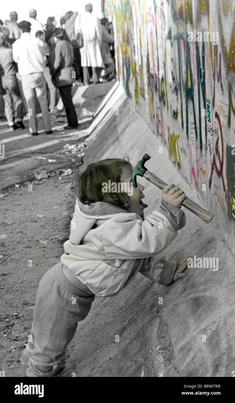 Fall of the Berlin Wall, young child using a hammer, Saturday the 11th of November 1989 Stock Photo