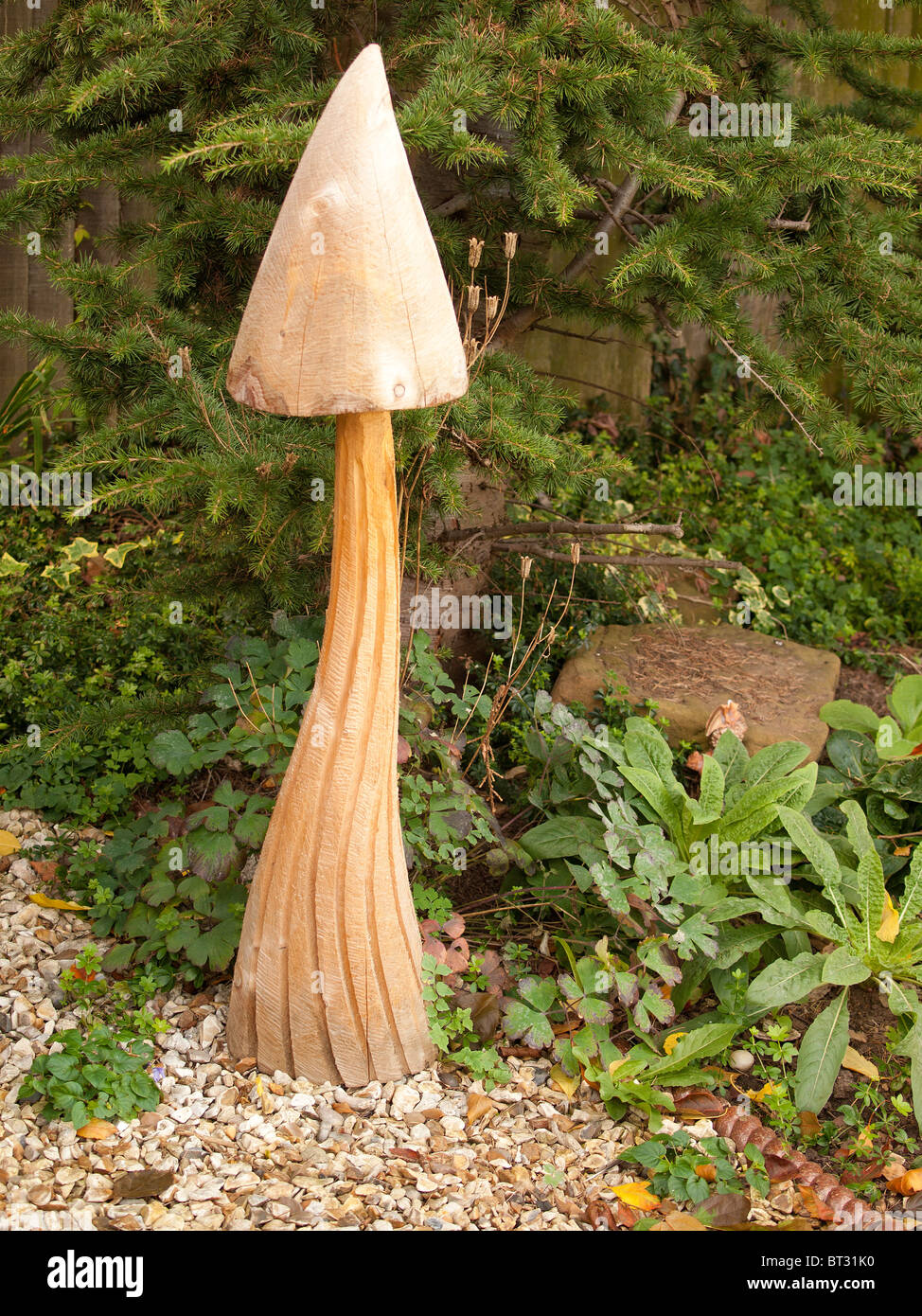 A tall wooden mushroom garden ornament Stock Photo