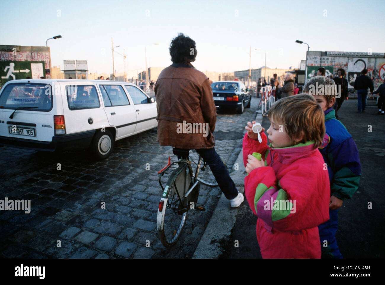 A child blows bubbles as carsfreely cross the border of East and West Berlin at Potsdamer Platz. Dec. 21 1989. (BSLOC 2011 3 55) Stock Photo