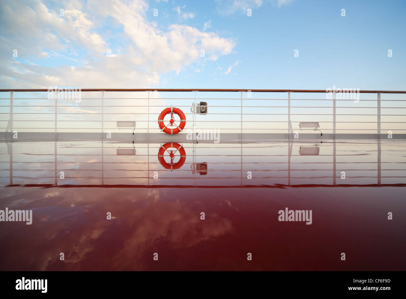 saving buoy in deck of cruise ship. deck shining by morning sun. reflection in deck Stock Photo