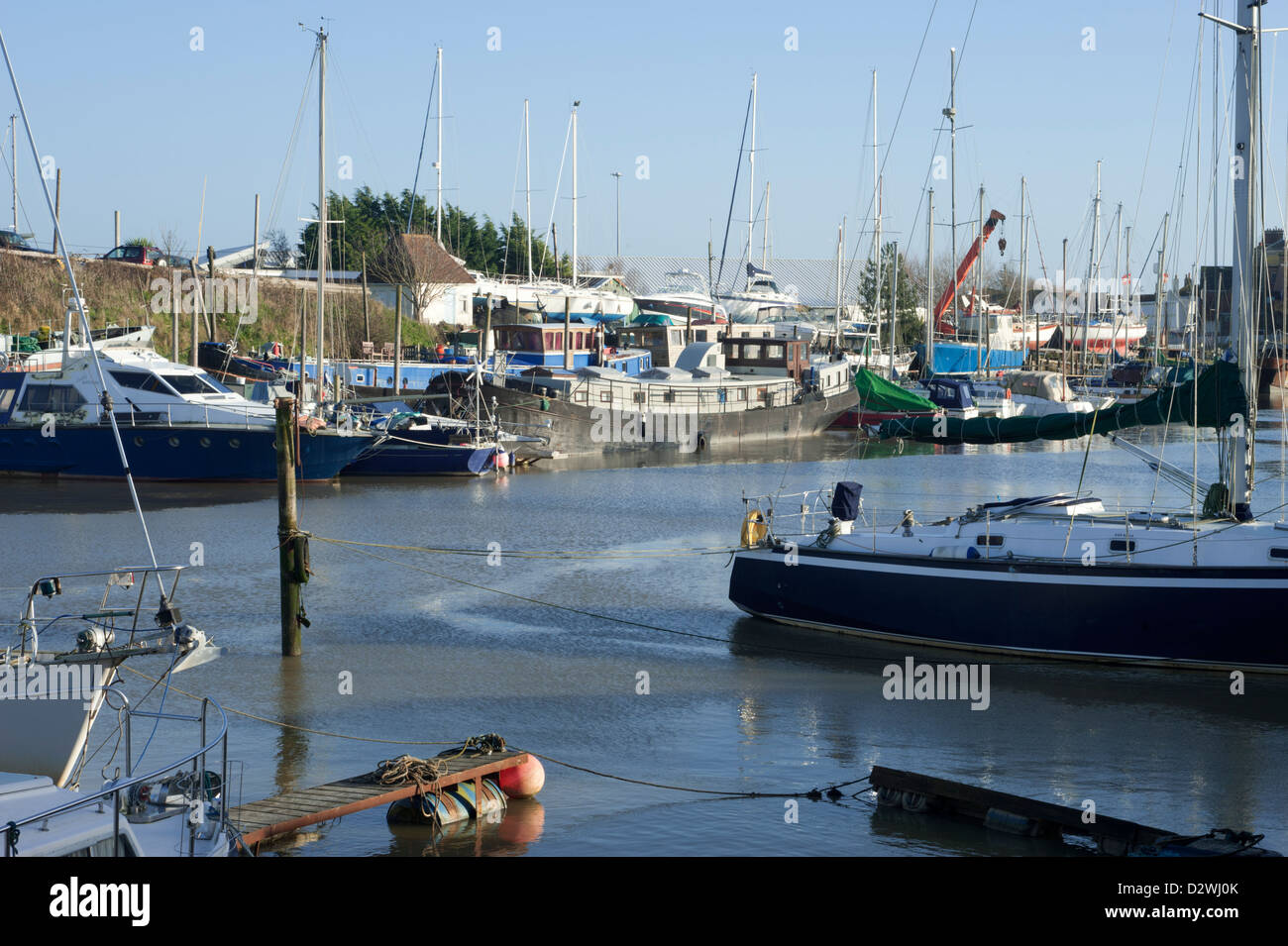 The River Ouse at Denton Island, showing a number of boats in various states of repair. Near Newhaven, East Sussex, England, UK. Stock Photo