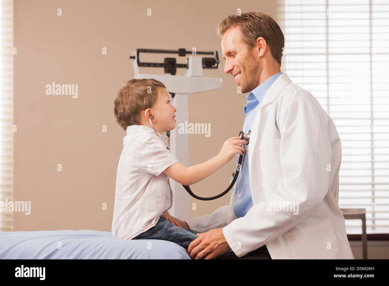 Boy (2-3) listening heartbeat of pediatrician Stock Photo