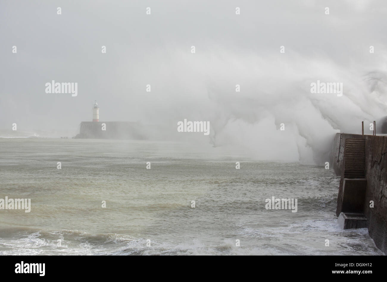 Huge waves crash into the harbour wall in Newhaven, East Sussex as the storm, St. Jude, hits land. Stock Photo