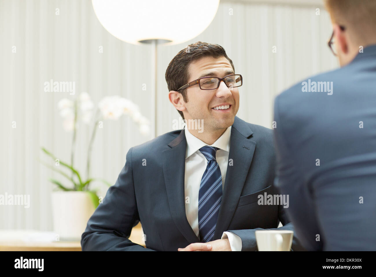 Businessmen talking in office Stock Photo