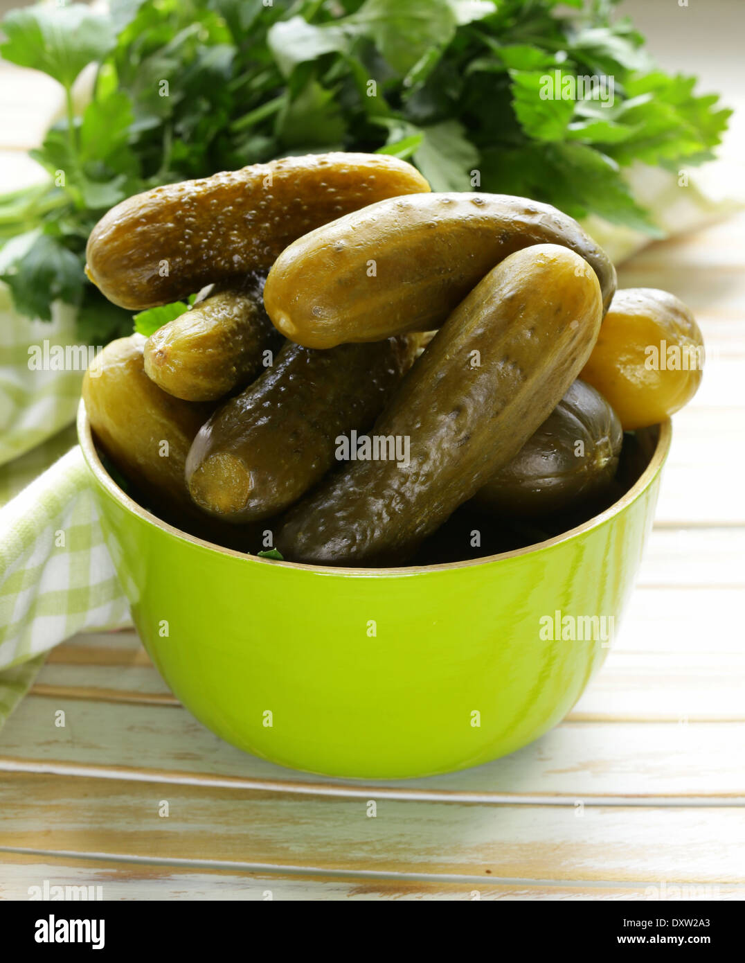 pickled cucumbers in green wooden bowl Stock Photo