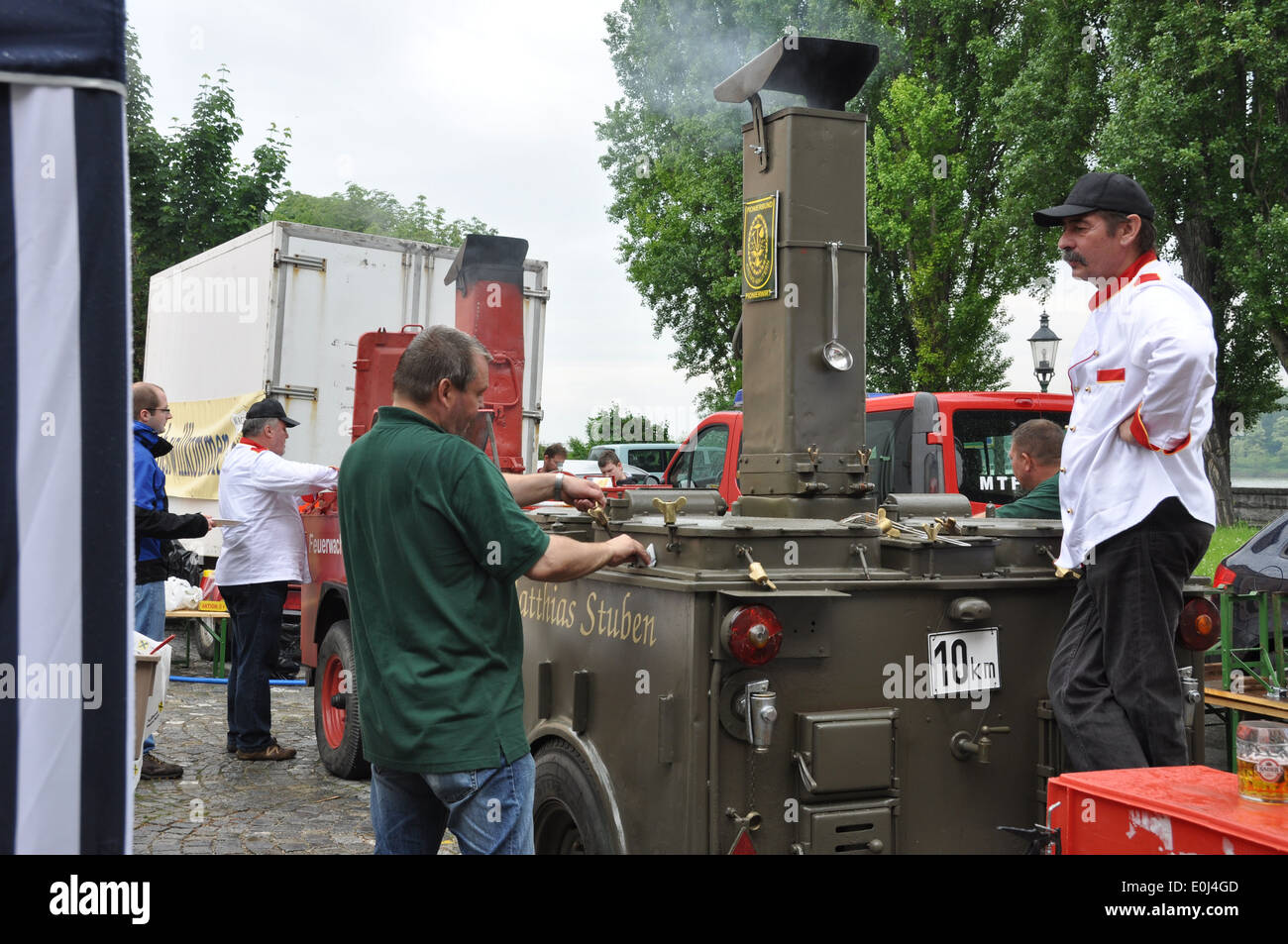 An Austrian cook serving up soup cooked in a modified army vehicle as as stove. Stock Photo