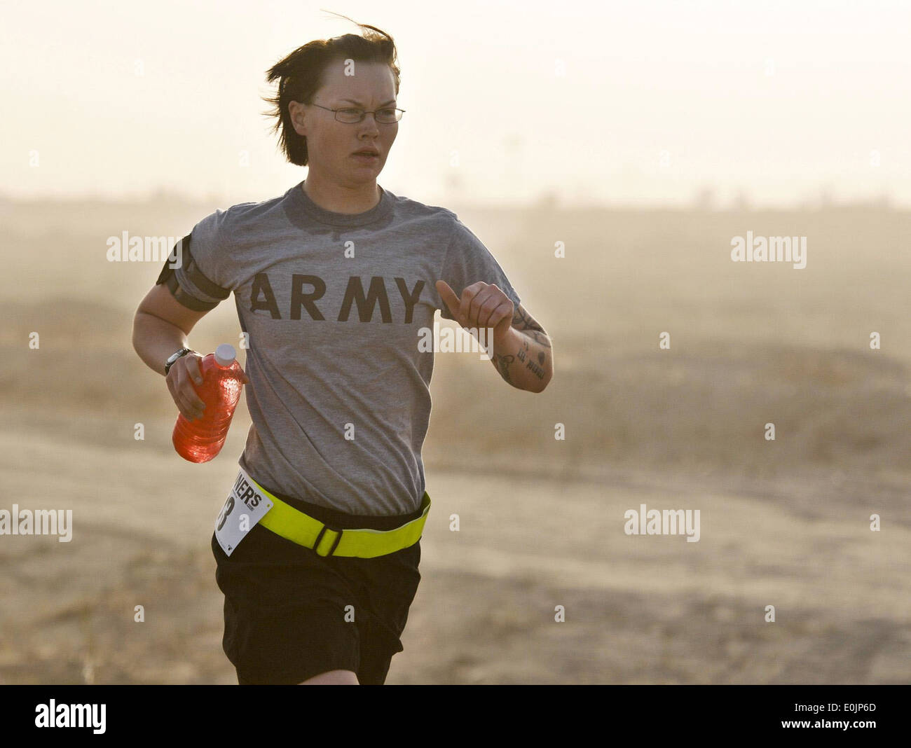 U.S. Army Cpl. Bevin Cook, 272nd Military Police Company, U.S. Division-North, runs the Task Force 26.2 Half Marathon at Contin Stock Photo