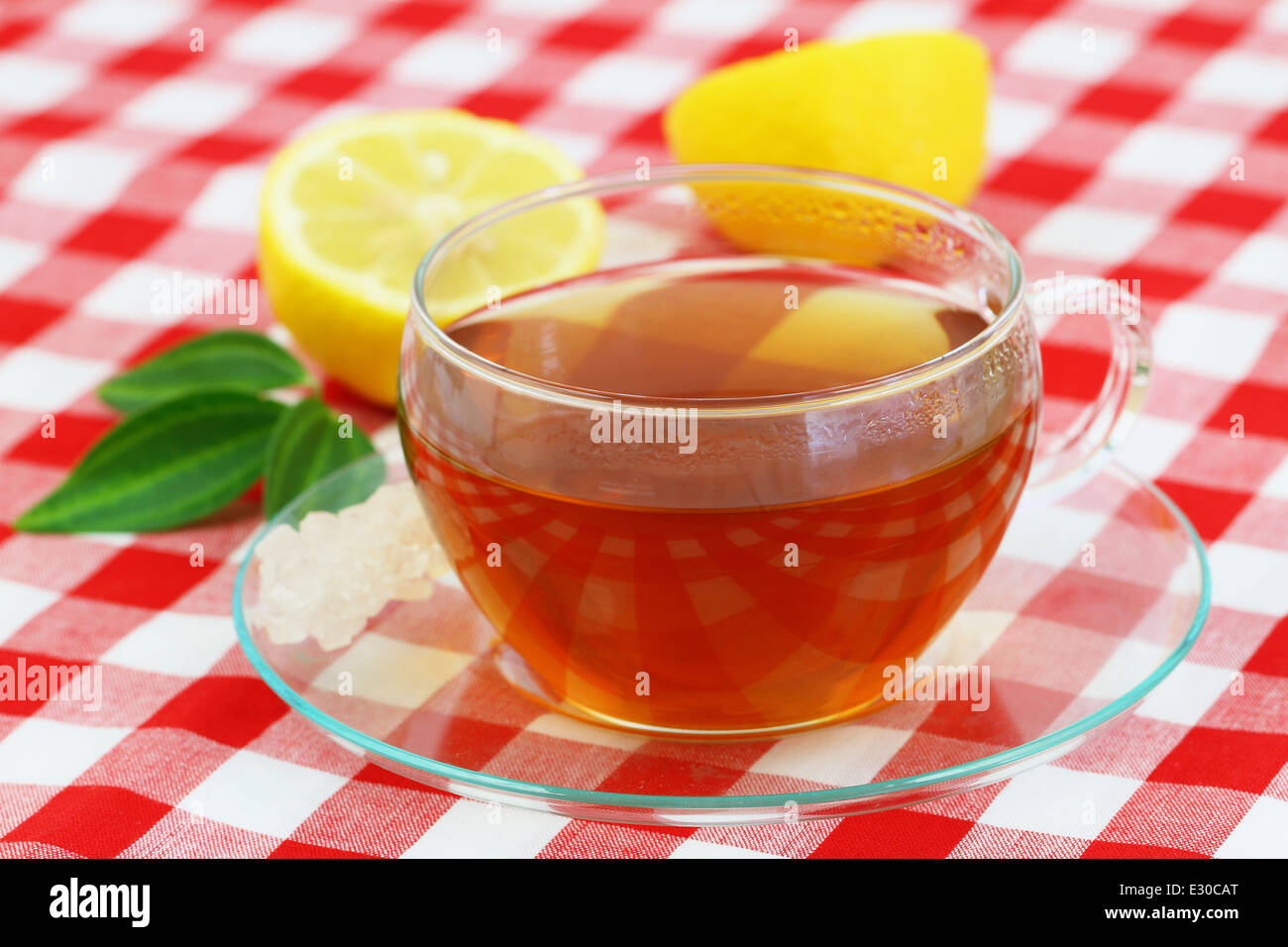 Cup of tea and lemon on checkered cloth Stock Photo