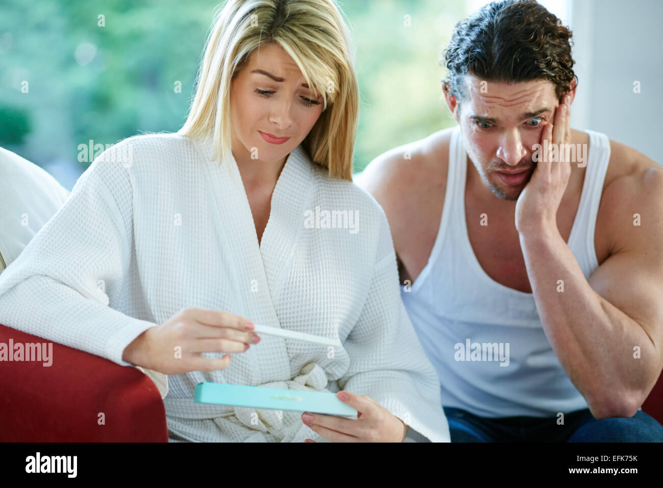 Unhappy couple finding out she is pregnant Stock Photo