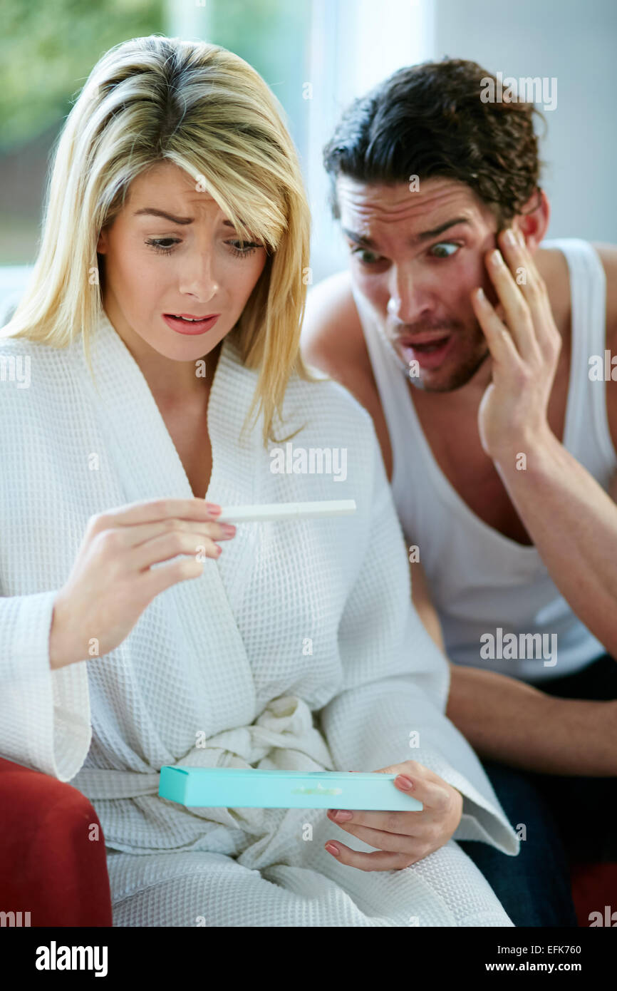 Unhappy couple finding out she is pregnant Stock Photo