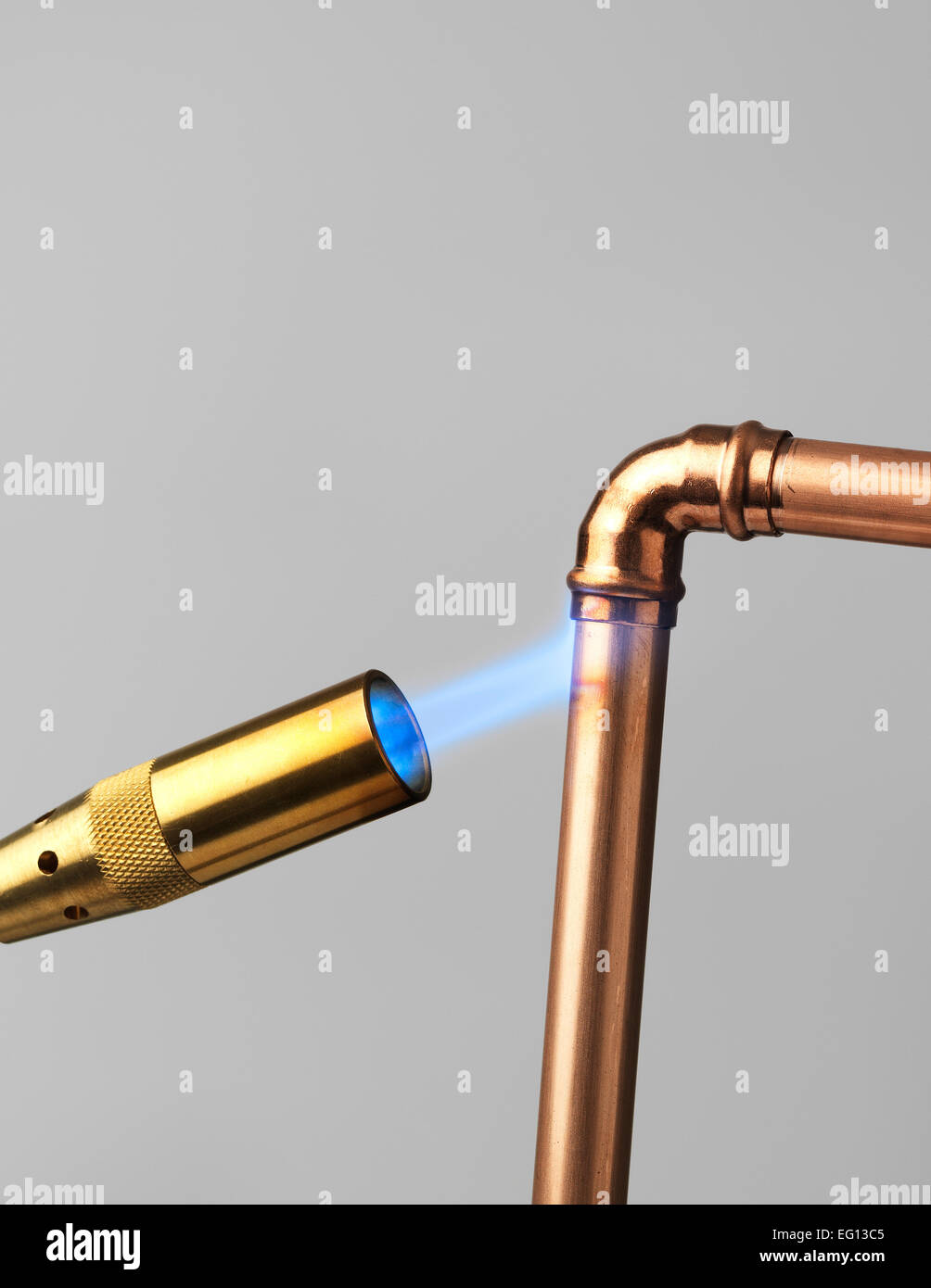 Blowtorch with flame on gray Stock Photo