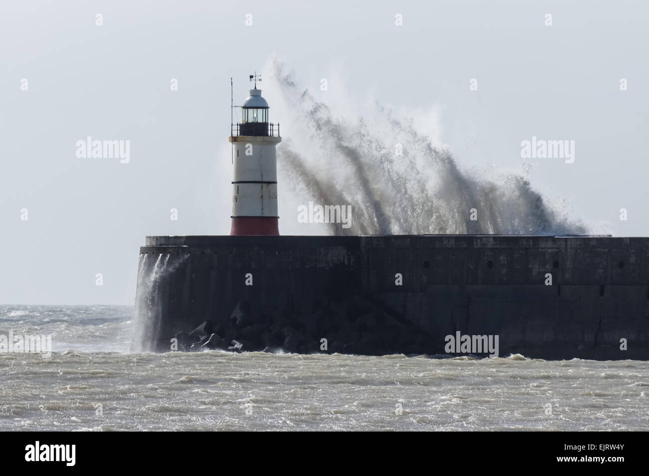 Huge waves crash over the Newhaven lighthouse and the harbour wall, Newhaven, East Sussex England United Kingdom UK Stock Photo