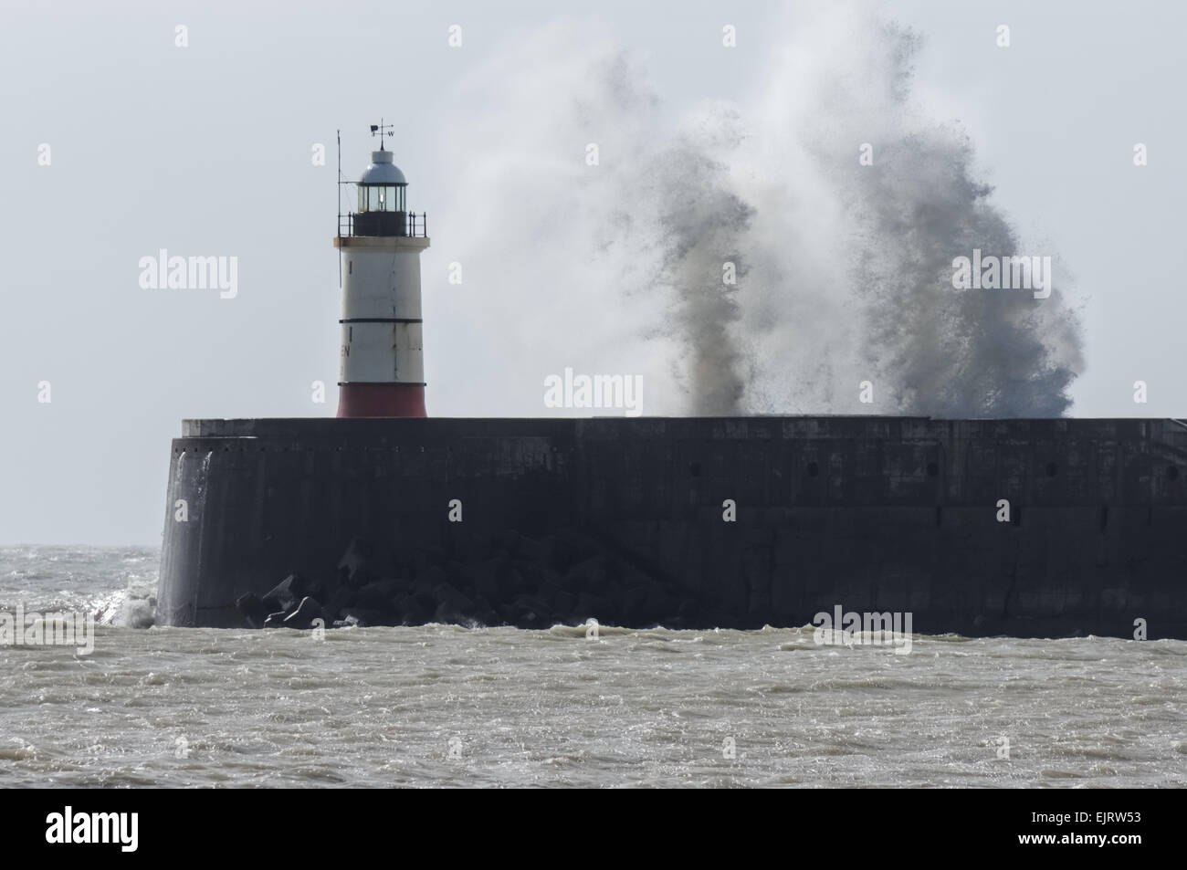 Huge waves crash over the Newhaven lighthouse and the harbour wall, Newhaven, East Sussex England United Kingdom UK Stock Photo