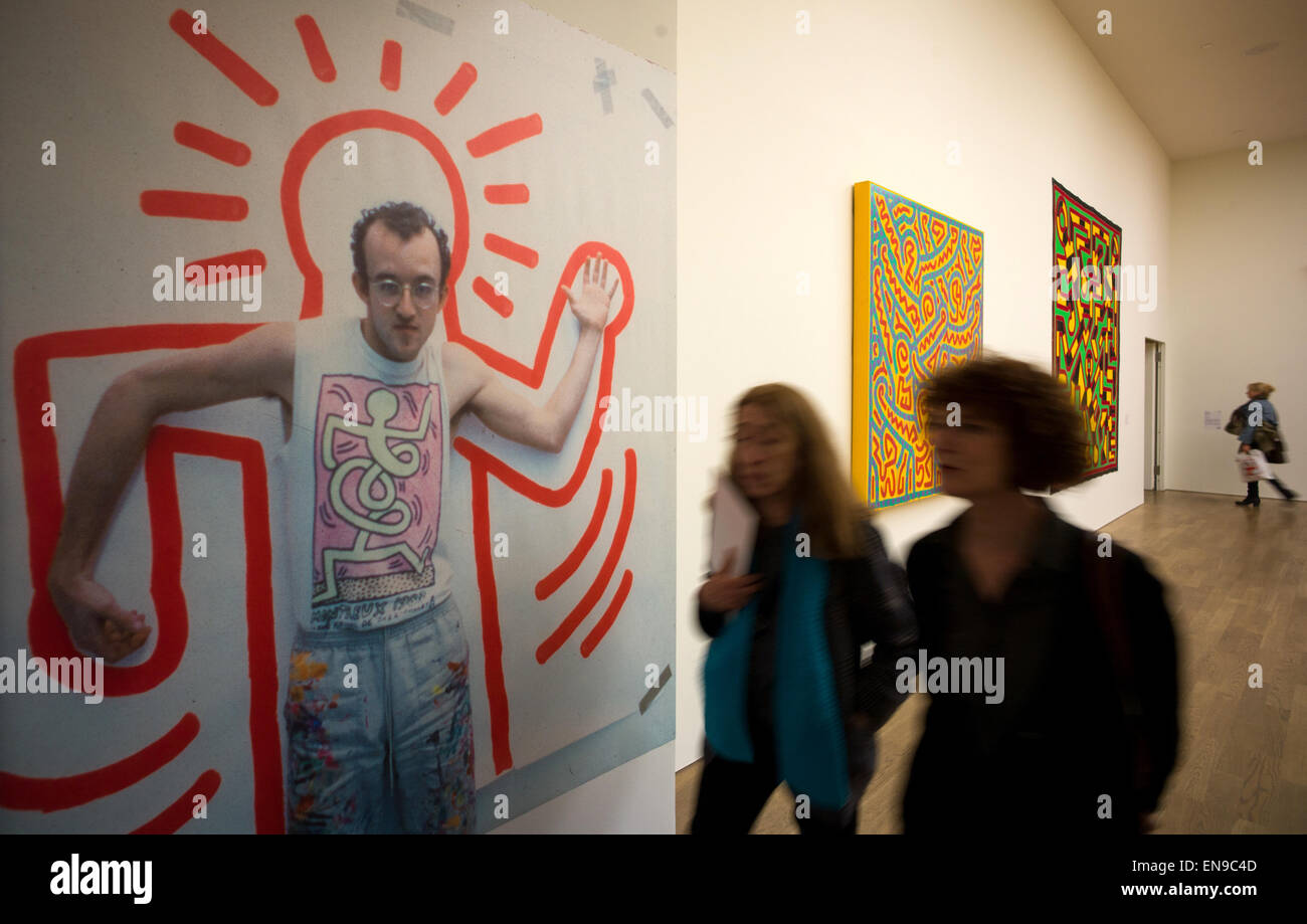 Munich, Germany. 30th Apr, 2015. Visitors look around the exhibition 'Keith Haring - The Political Line' in Munich, Germany, 30 April 2015. The mostly large-format pictures and objects can be seen in the Kunsthalle of the Hypo-Cultural Foundation until 30 August 2015. The artist left most of his work untitled. Photo: PETER KNEFFEL/dpa/Alamy Live News Stock Photo