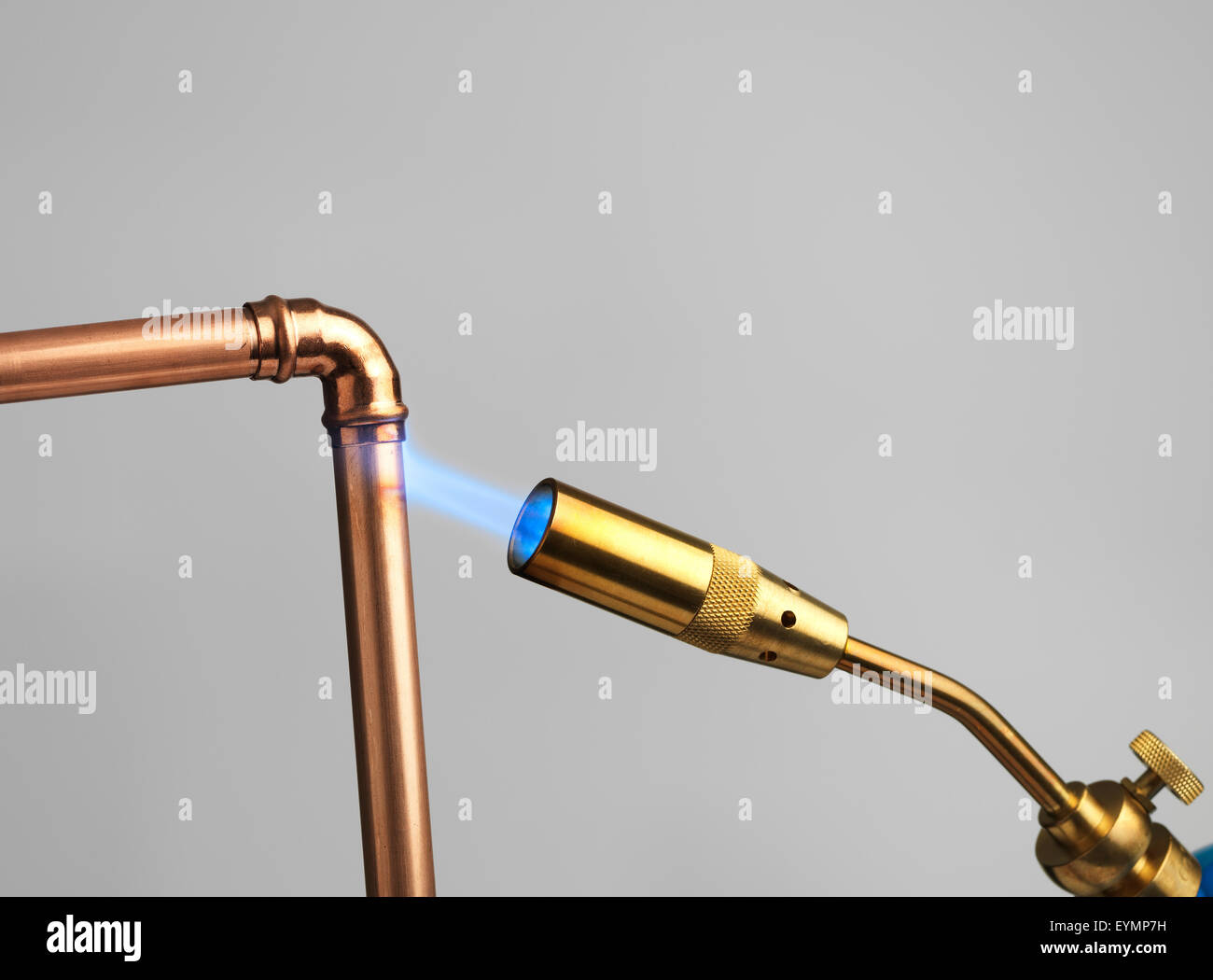 Blowtorch with flame on gray Stock Photo