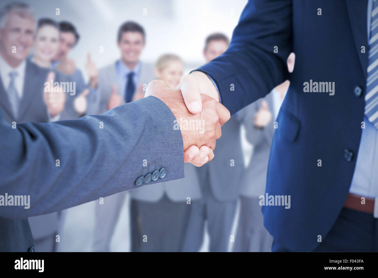 Composite image of businessmen shaking hands Stock Photo