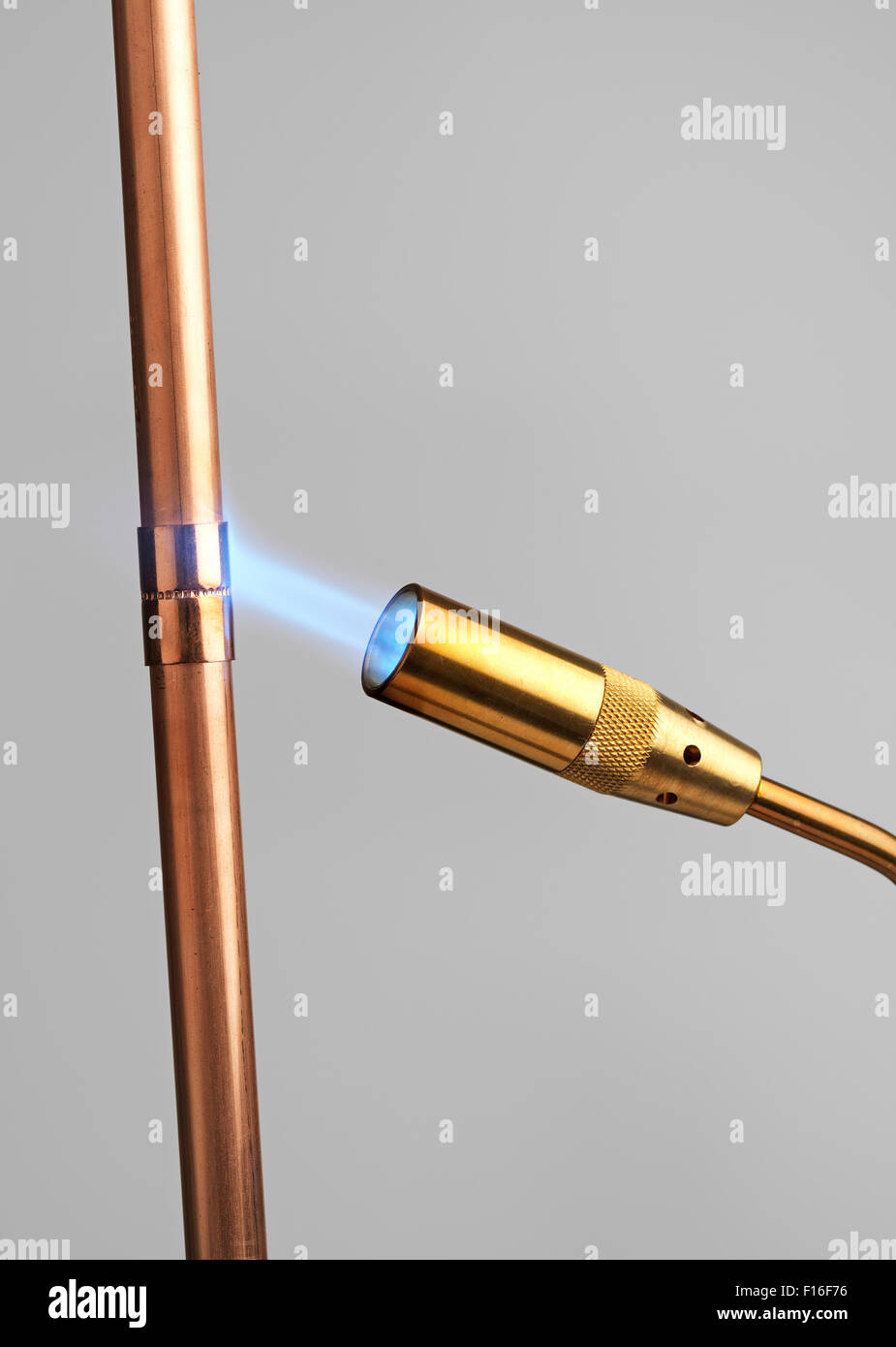 Blowtorch with flame on gray Stock Photo