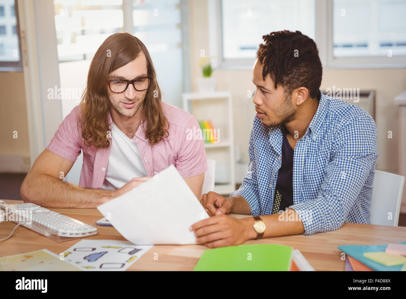 Businessmen discussing over document Stock Photo