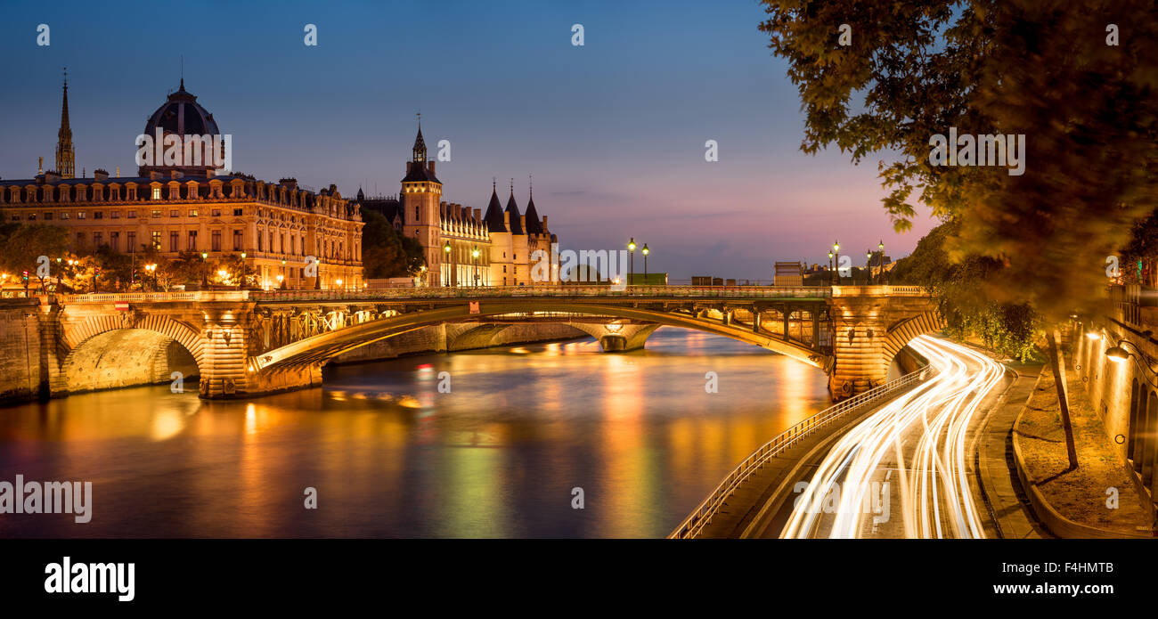 Seine River at Dusk with Pont Notre Dame and the Conciergerie on Ile de la Cite, Paris, France. Stock Photo