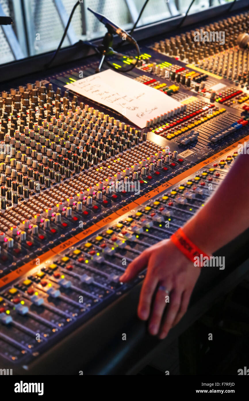 Knobs and slide controls of mixing console / audio mixer at concert Stock Photo