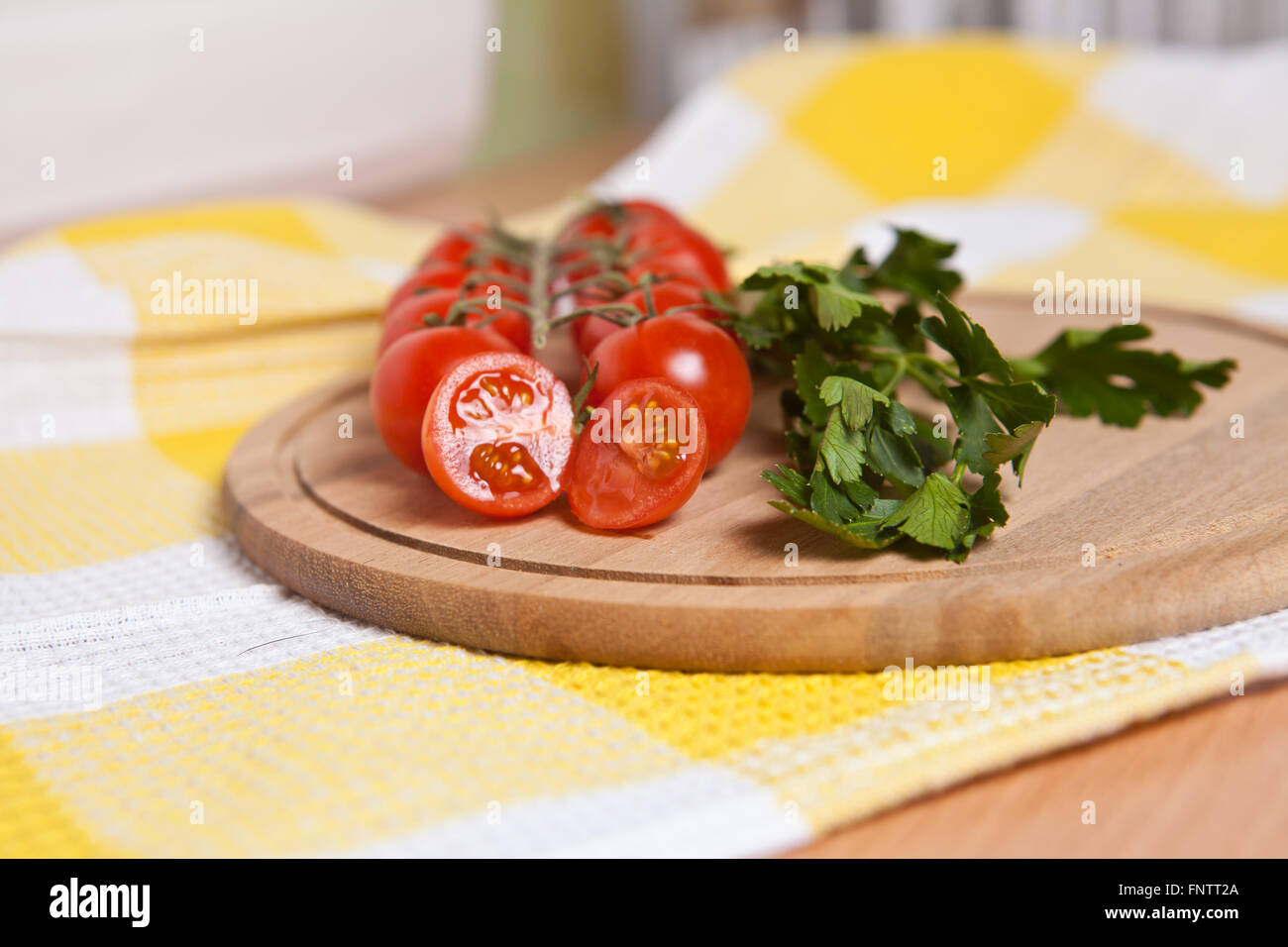 cherry tomatoes, cucumbers and parsley close-up on the board Stock Photo