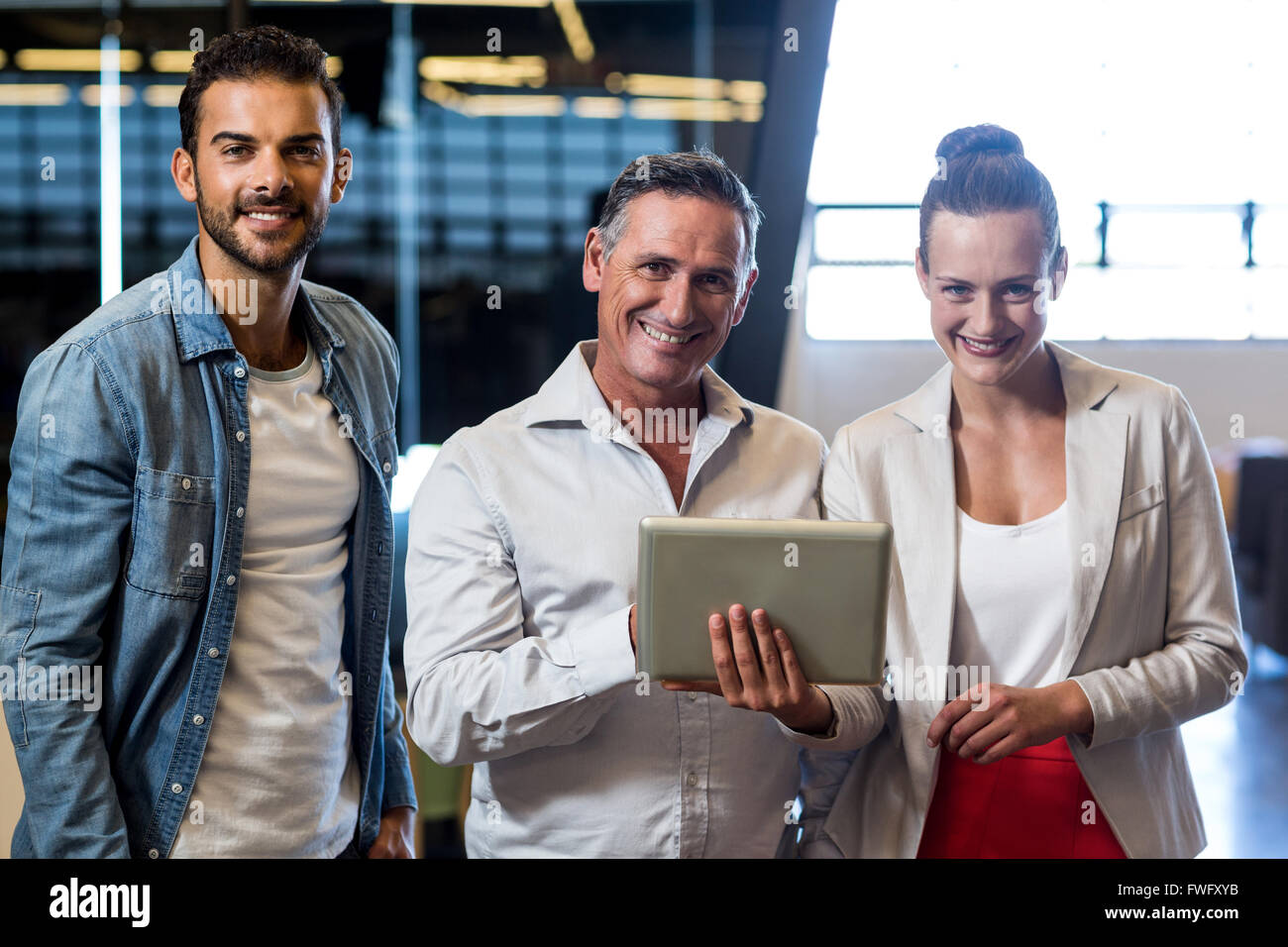 Businessmen and businesswoman holding digital tablet Stock Photo