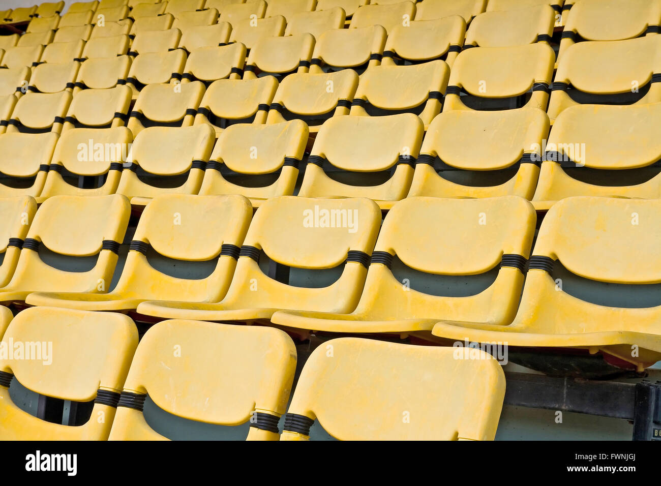 Yellow Seat Pattern in Football Stadium Stock Photo