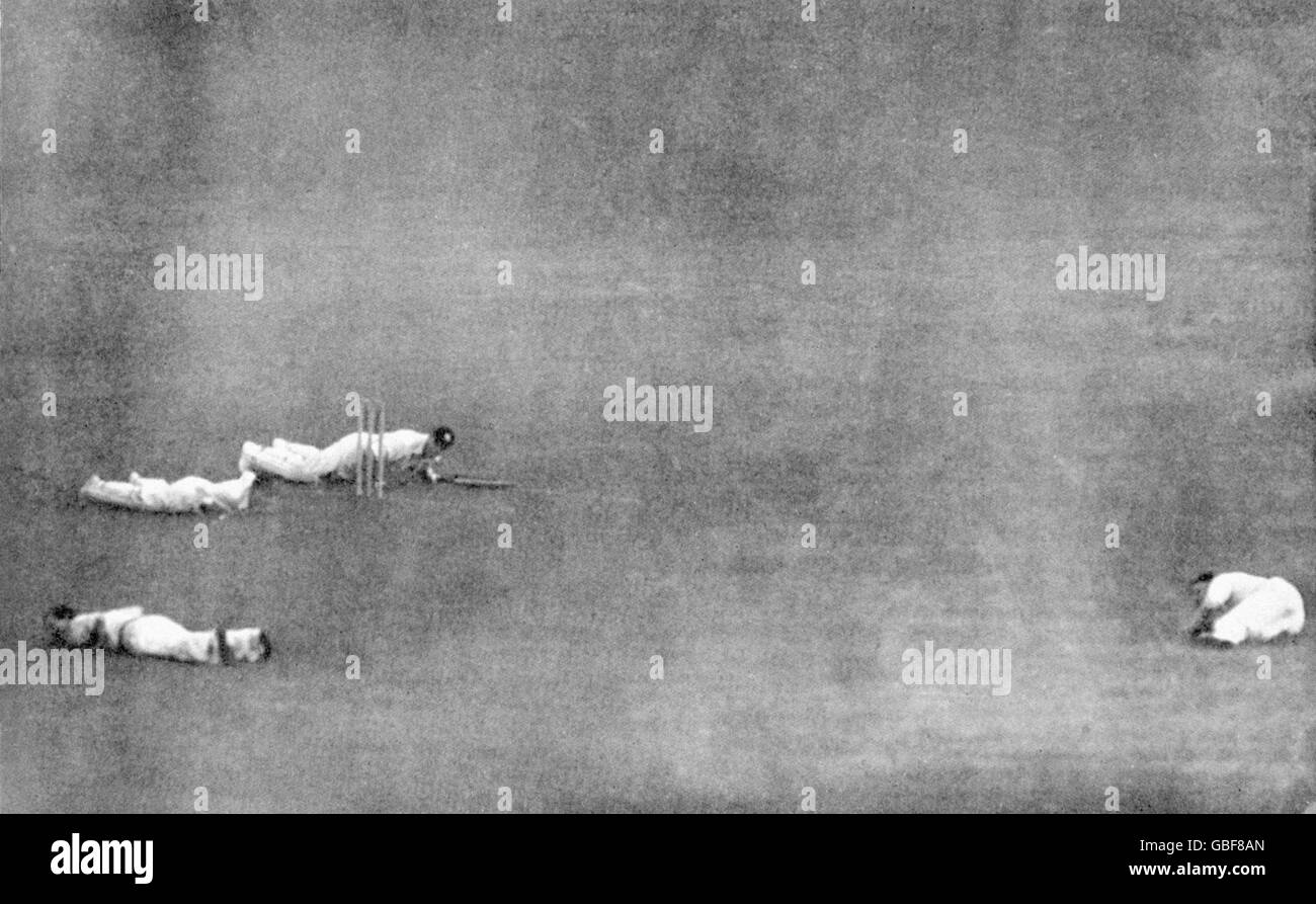 Players hit the deck as a V1 flying-bomb falls in the vicinity of Lord's; Army's Jack Robertson (batting), RAF's Andy Wilson (wicketkeeper), Bill Edrich (bottom l) and Austin Matthews (r). Stock Photo