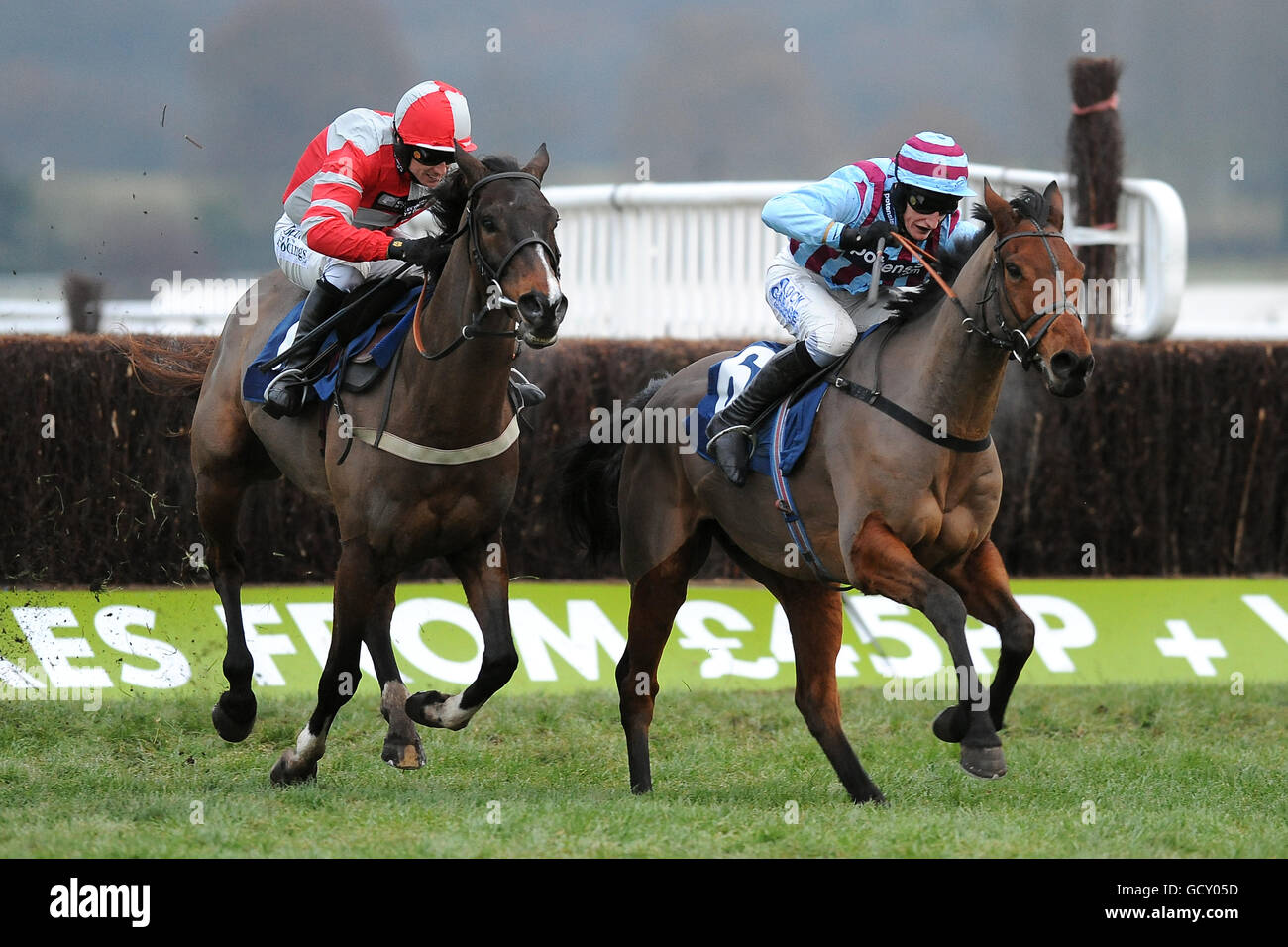 Horse Racing - Christmas Party Day - Newbury Racecourse. Jockey Paddy Brennan on Tartak (l) and Daryl Jacob on Breedsbreeze battle for the line in the totesport.com Peterborough Chase Stock Photo