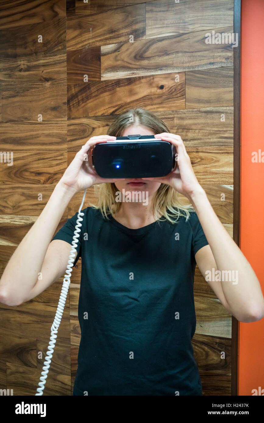 Woman wearing a virtual reality headset. Stock Photo