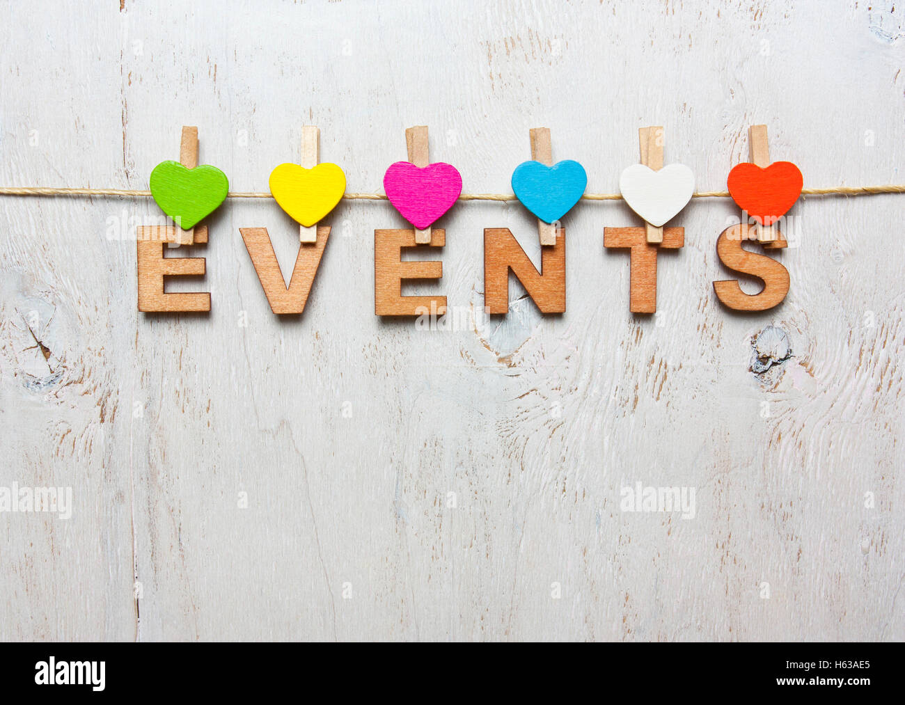 Word events of wooden letters on a white background with wooden clothespins Stock Photo