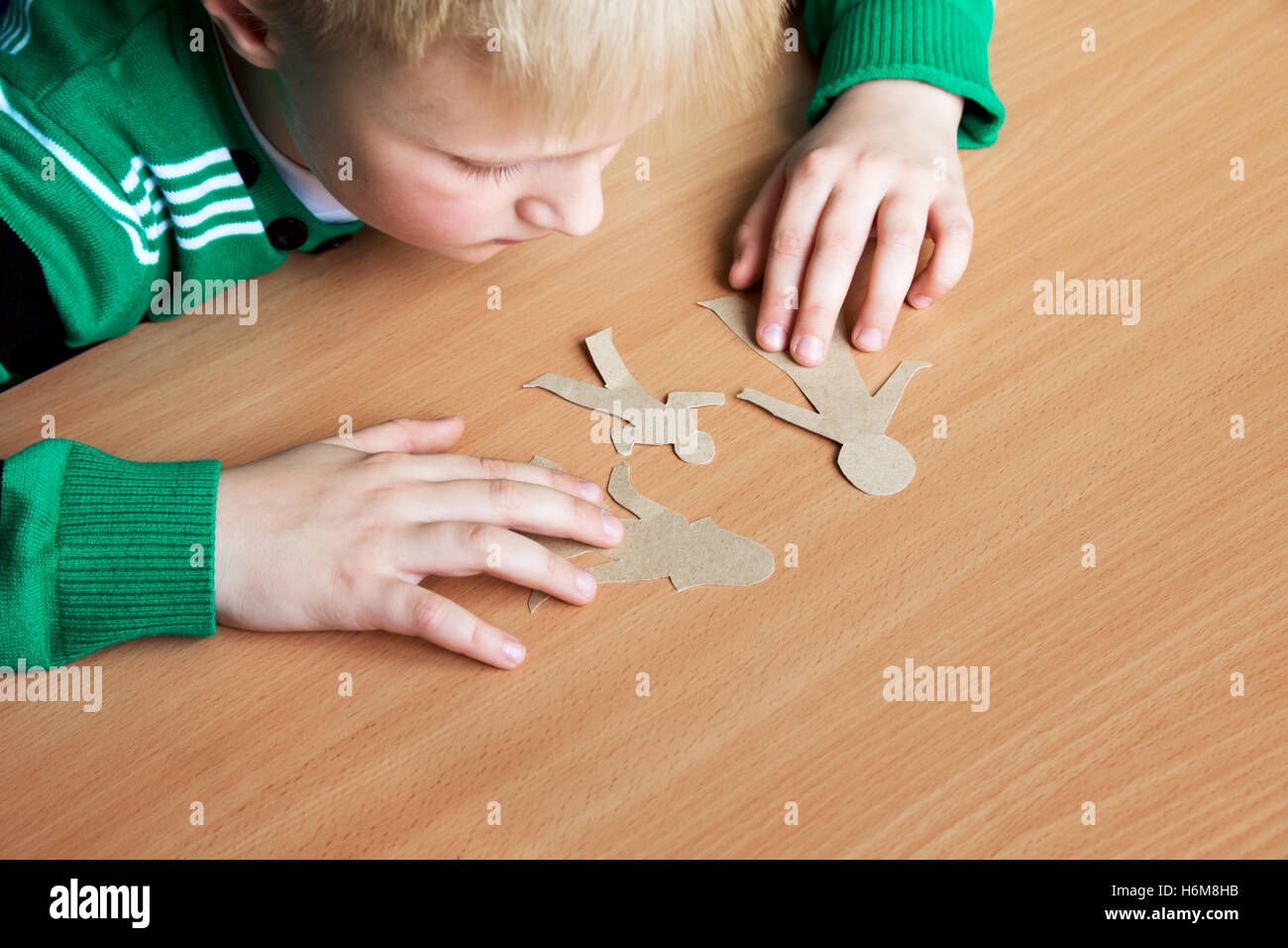 Confused child with broken paper family, custody, family problems, divorce, suffer concept Stock Photo