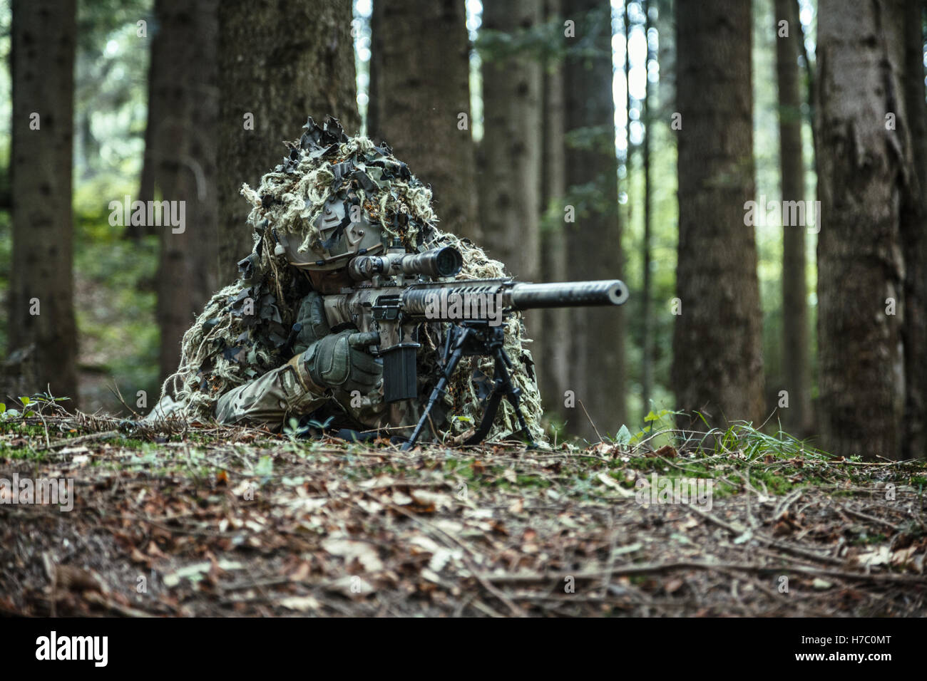 sniper wearing ghillie suit Stock Photo