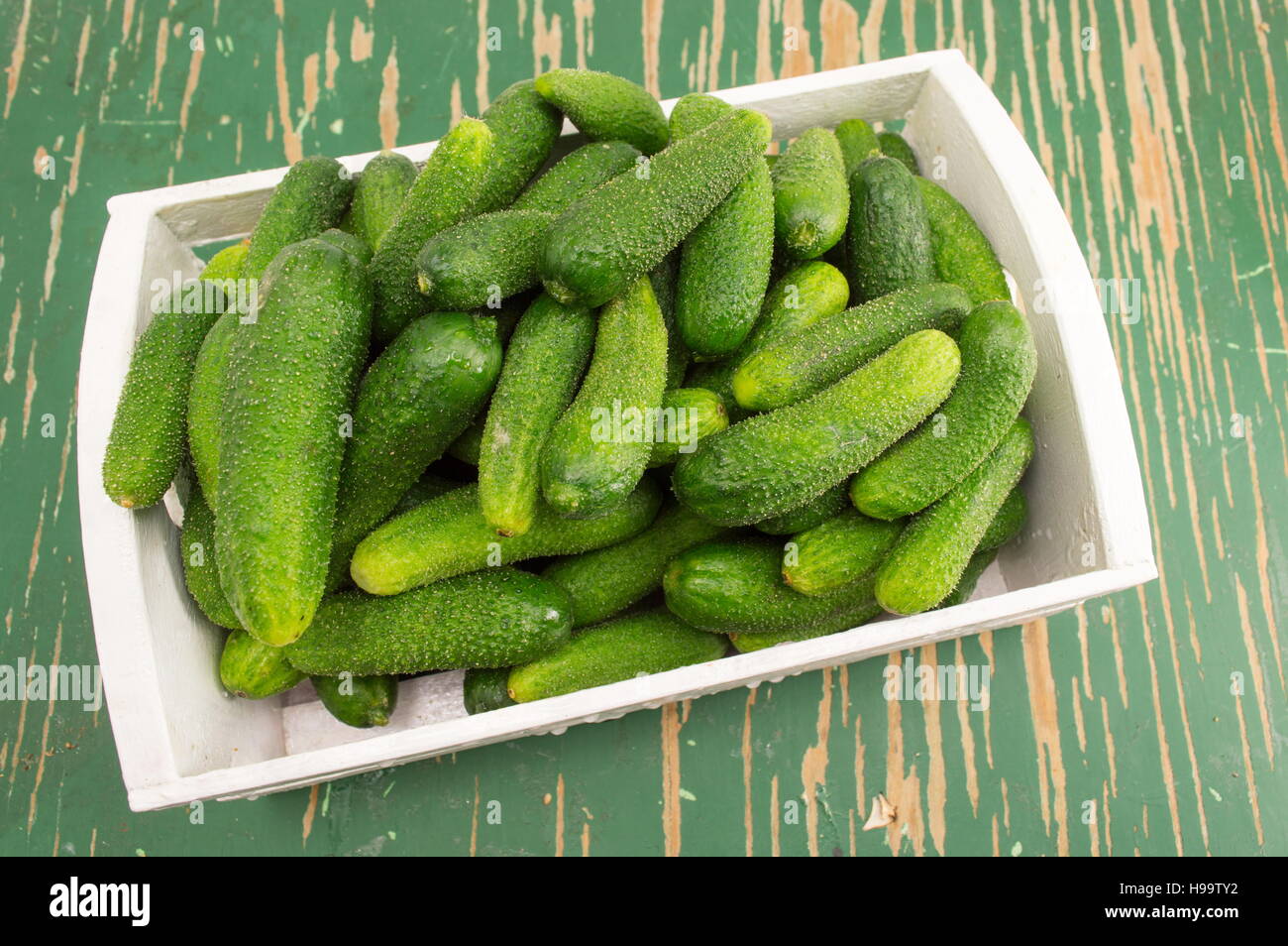 Fresh raw cucumbers in a wooden box Stock Photo