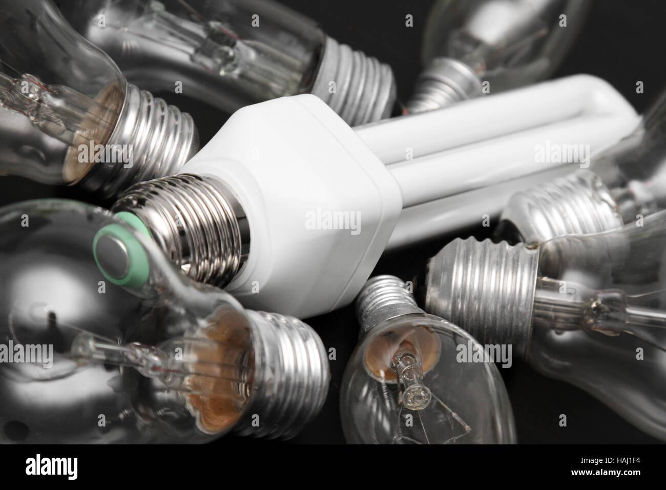 energy efficient bulb in the middle of old incandescent Stock Photo