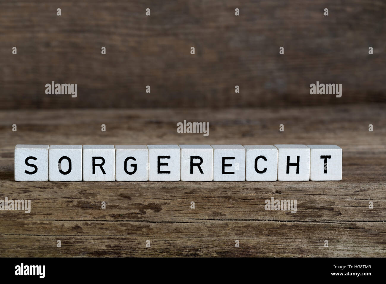 German word custody, written in cubes on wooden background Stock Photo