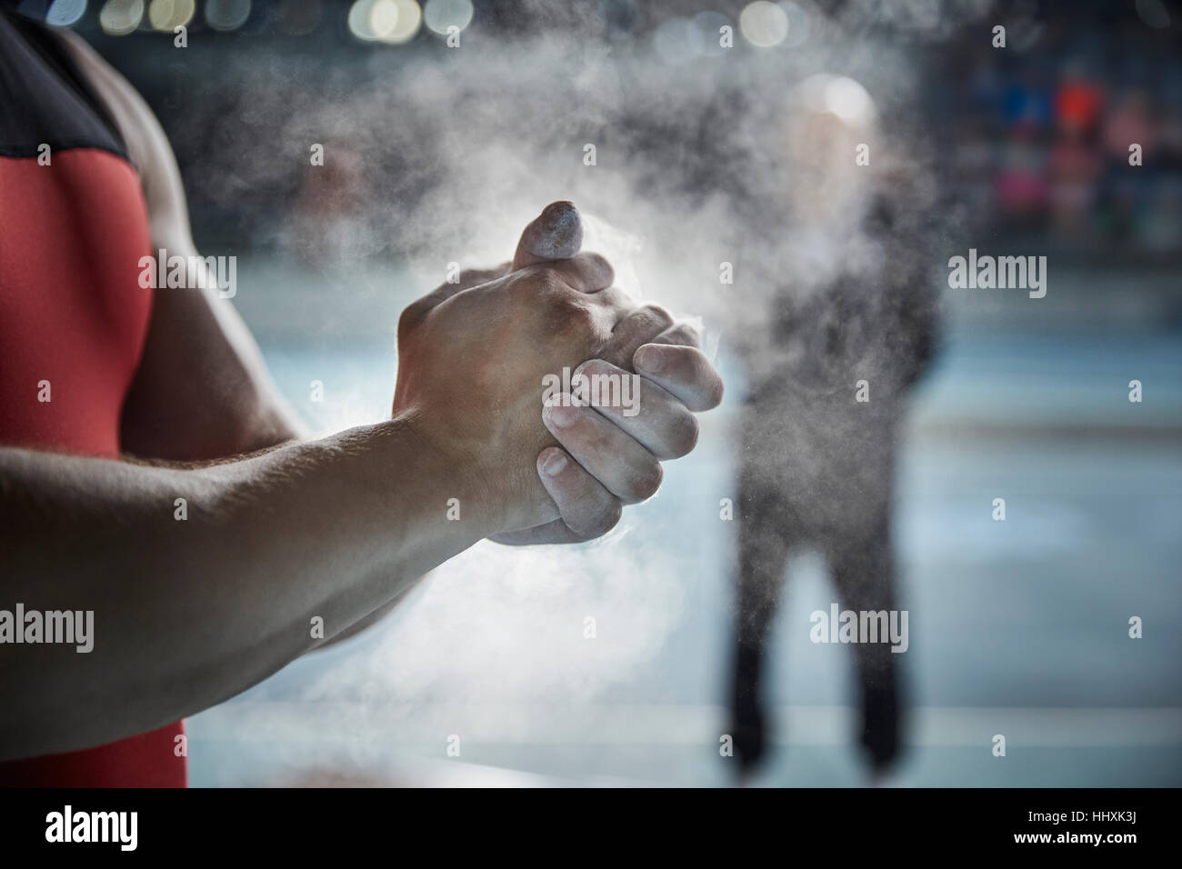 Close up male weightlifter applying chalk powder on hands Stock Photo