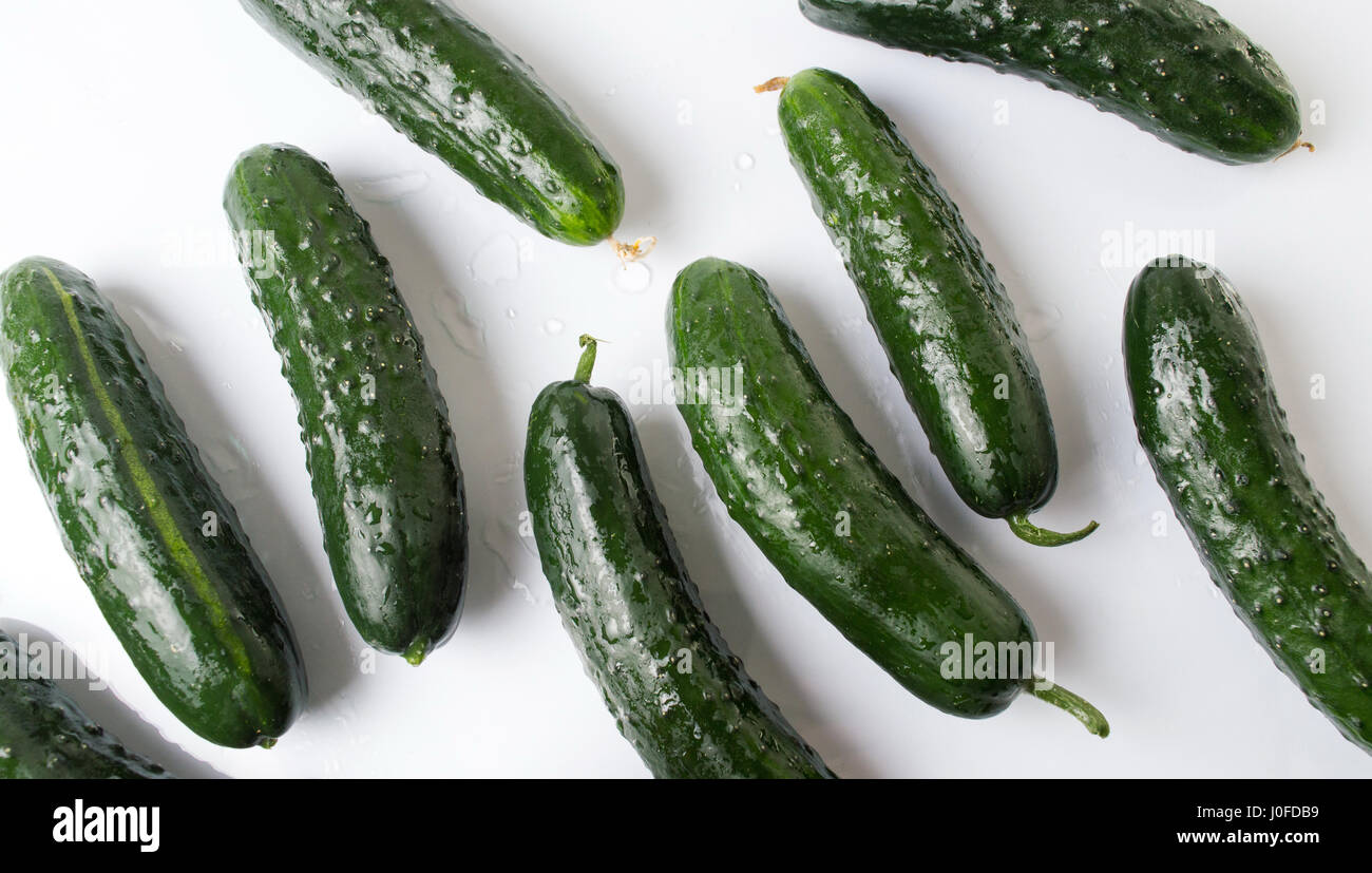 Fresh washed cucumbers on white wooden table Stock Photo