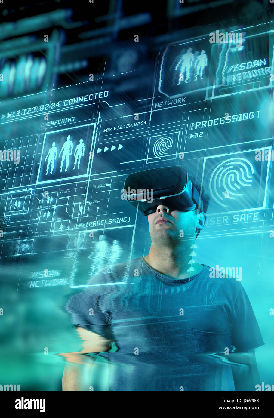 A young man wearing virtual reality (VR) goggles and headset with a projection of a digital information on display. Stock Photo