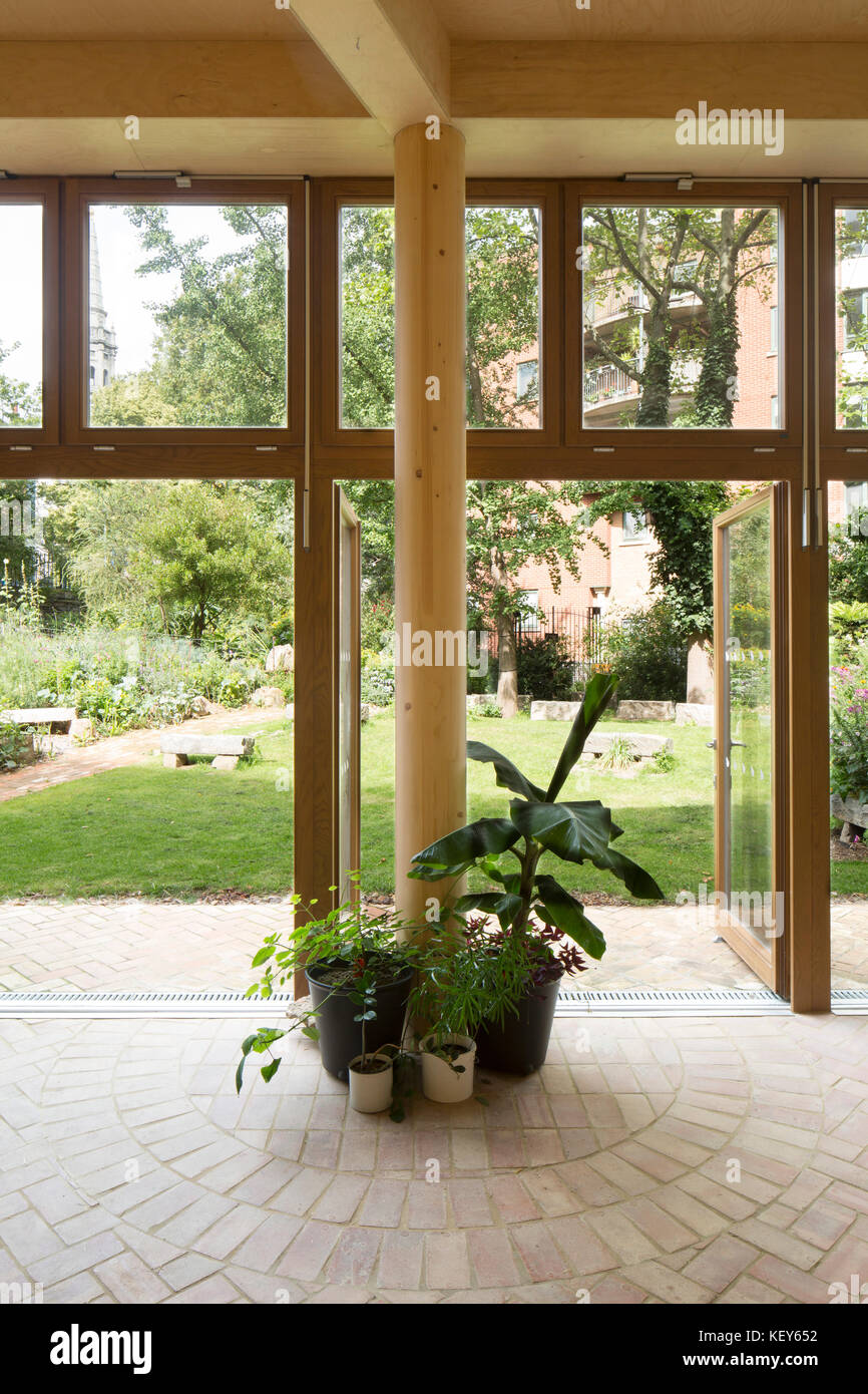 Interior view looking out to garden. Phoenix Community Gardens, London, United Kingdom. Architect: Office Sian Architecture & Design, 2017. Stock Photo